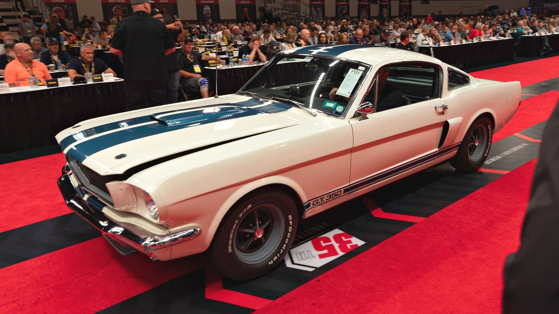 While car with blue stripes down the hood