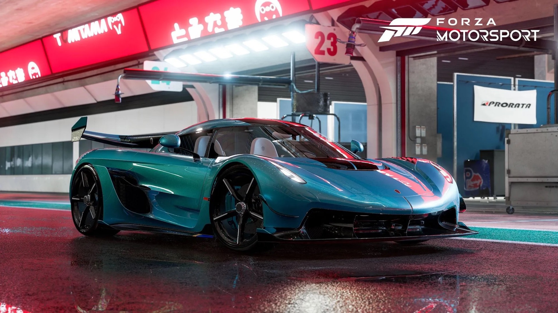 A teal, rain-soaked Koenigsegg Jesko poses dramatically under the lights of a race track pit lane.