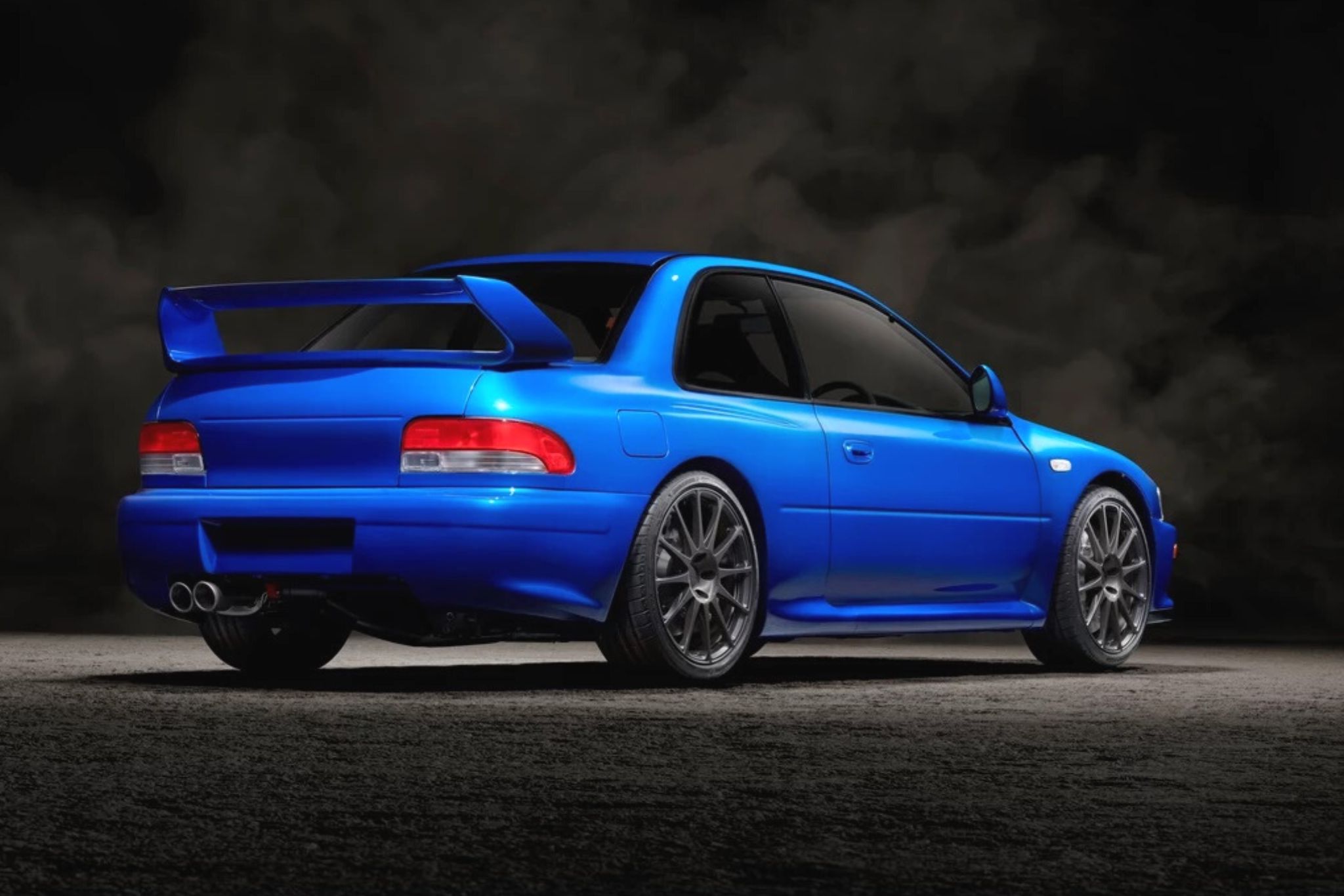 rear view of blue car in front of black background