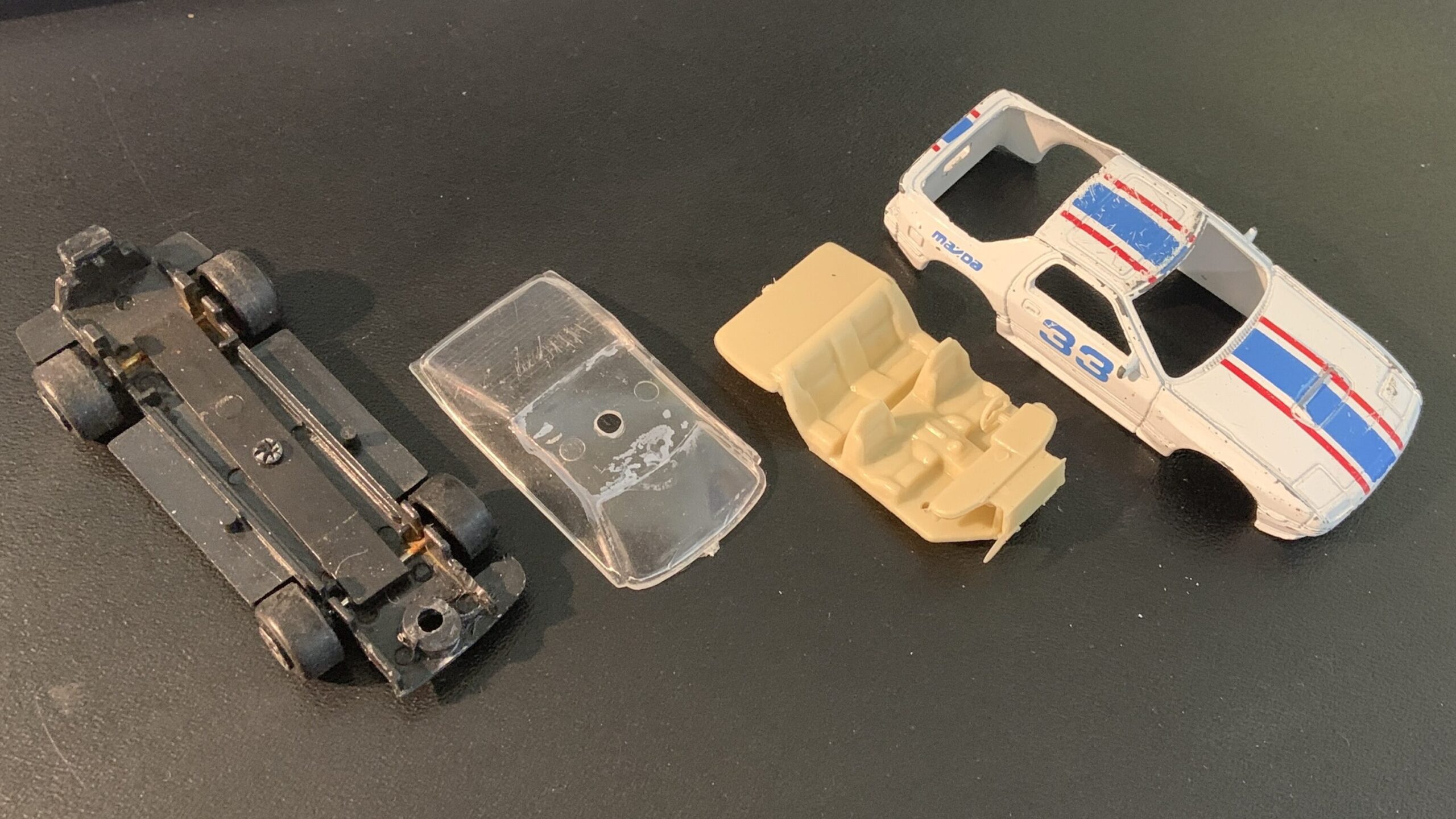 1:64-scale car broken down into pieces.