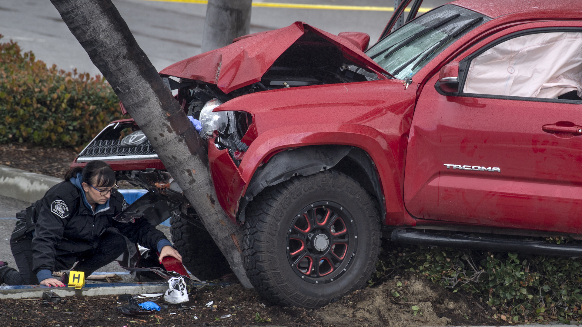 FULLERTON, CA - FEBRUARY 10: Heather Barclay, an accident investigator with the Fullerton Police Department, gathers evidence that was lodged underneath a pickup truck. The driver, identified as Christopher Solis, 22, veered onto a sidewalk and hit 9 pedestrians, police said. Some of the victims were trapped beneath the truck, according to authorities. (Photo by Mindy Schauer/MediaNews Group/Orange County Register via Getty Images)