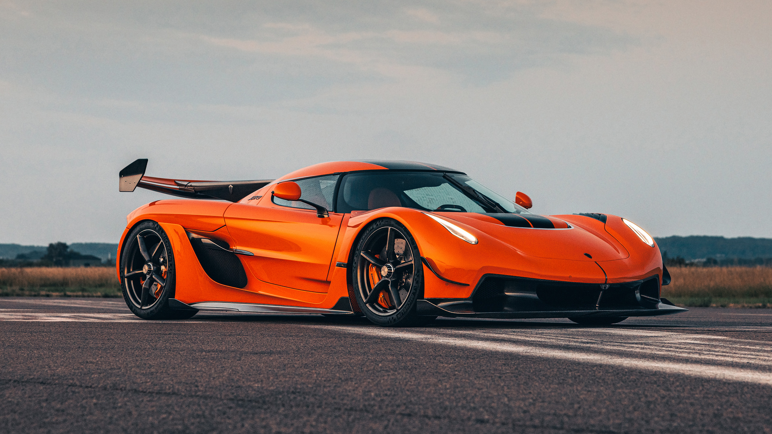 Orange Koenigsegg Jesko front three-quarter view.