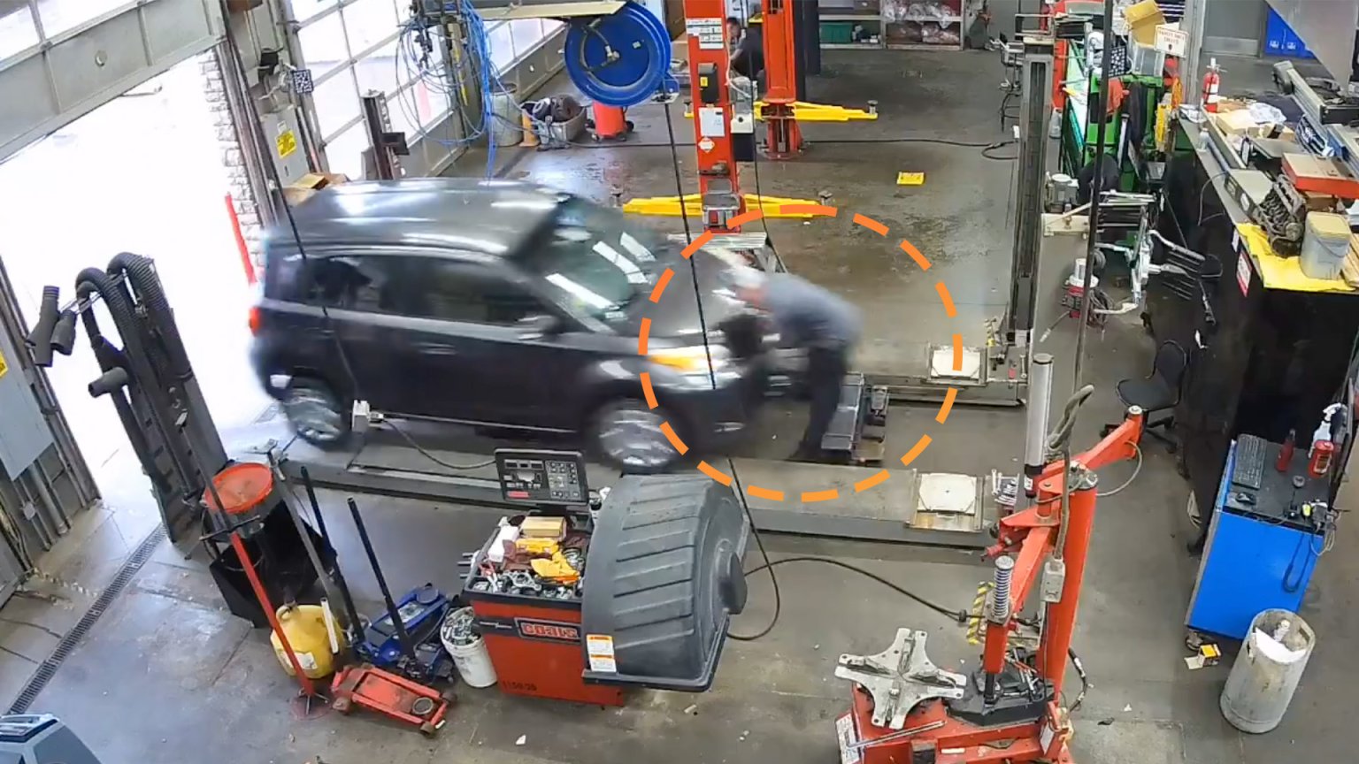 Mechanic Miraculously Survives Hit From Runaway Car Barreling Into Shop
