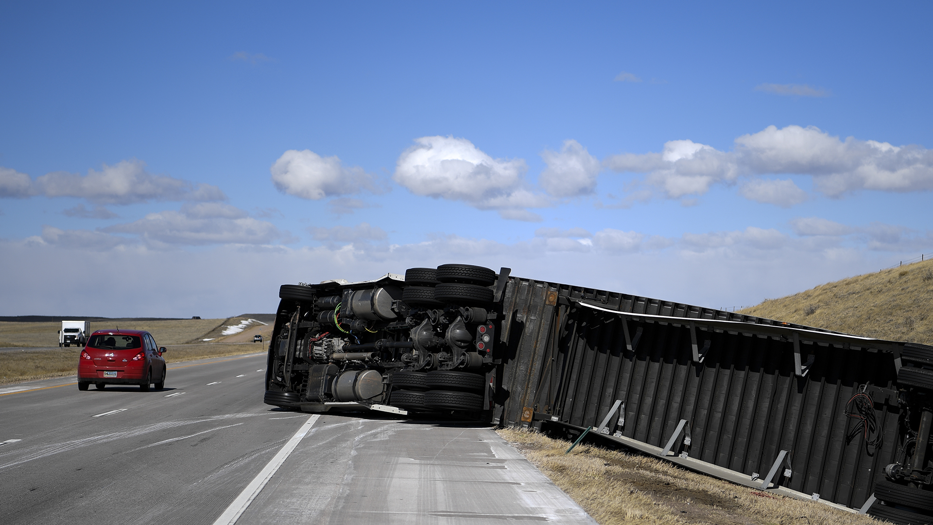 WELLINGTON, CO - MARCH 5: A semi truck that was blown over north of Wellington lies on its side as traffic passes by during a wind storm on Friday, March 5, 2018. Wind speed were in excess of 60 miles per hour in places near the Wyoming-Colorado border. (Photo by AAron Ontiveroz/The Denver Post via Getty Images)