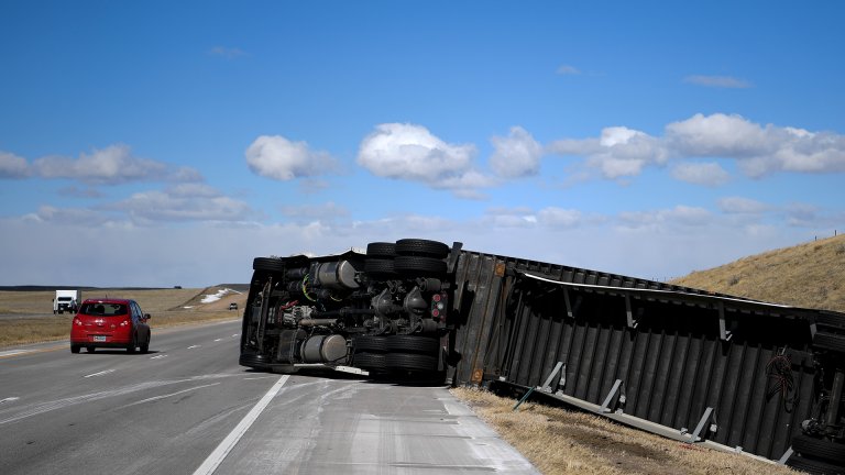 WELLINGTON, CO - MARCH 5: A semi truck that was blown over north of Wellington lies on its side as traffic passes by during a wind storm on Friday, March 5, 2018. Wind speed were in excess of 60 miles per hour in places near the Wyoming-Colorado border. (Photo by AAron Ontiveroz/The Denver Post via Getty Images)