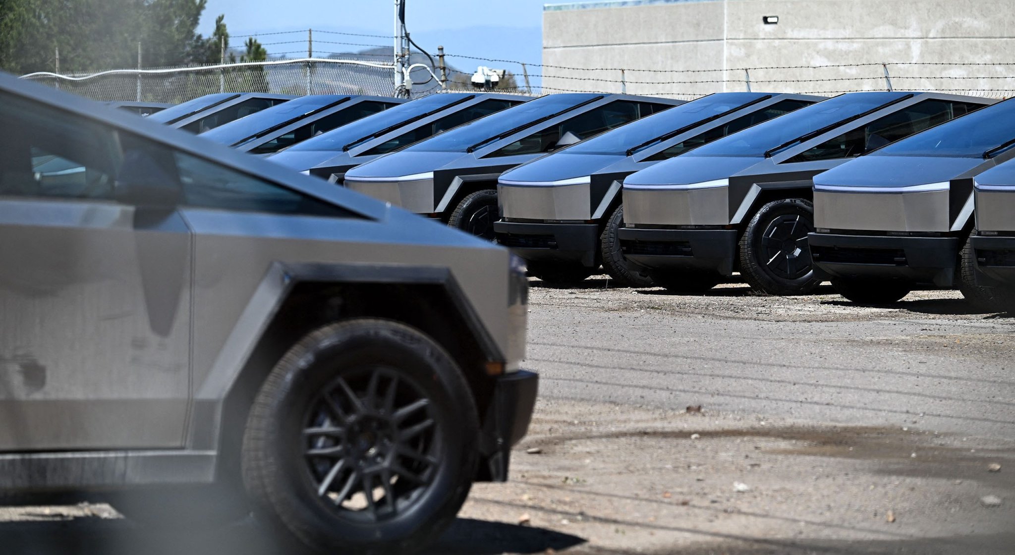 Tesla Cybertruck electric vehicles sit parked in a storage lot in San Diego, California on April 11, 2025.