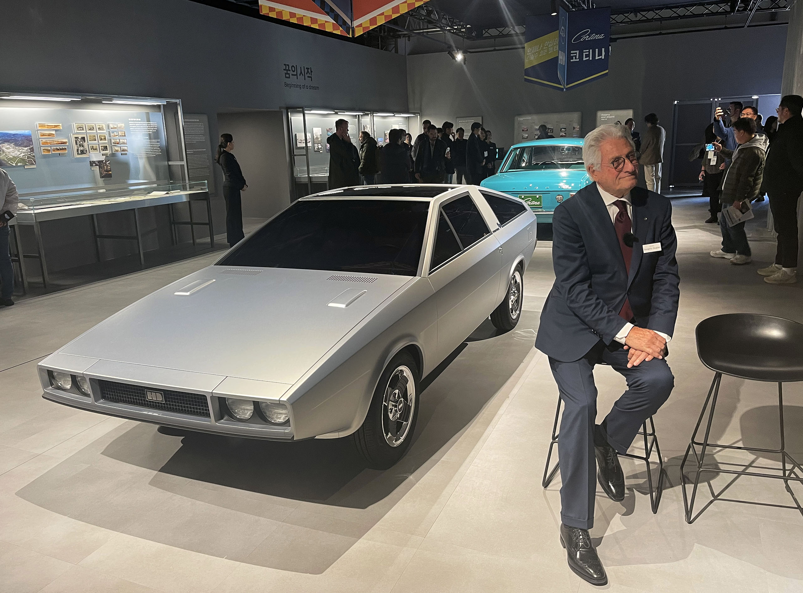 Here Giugiaro, seen in 2023, sits beside the Hyundai Pony concept he designed back in 1974, that the automaker recently restored.