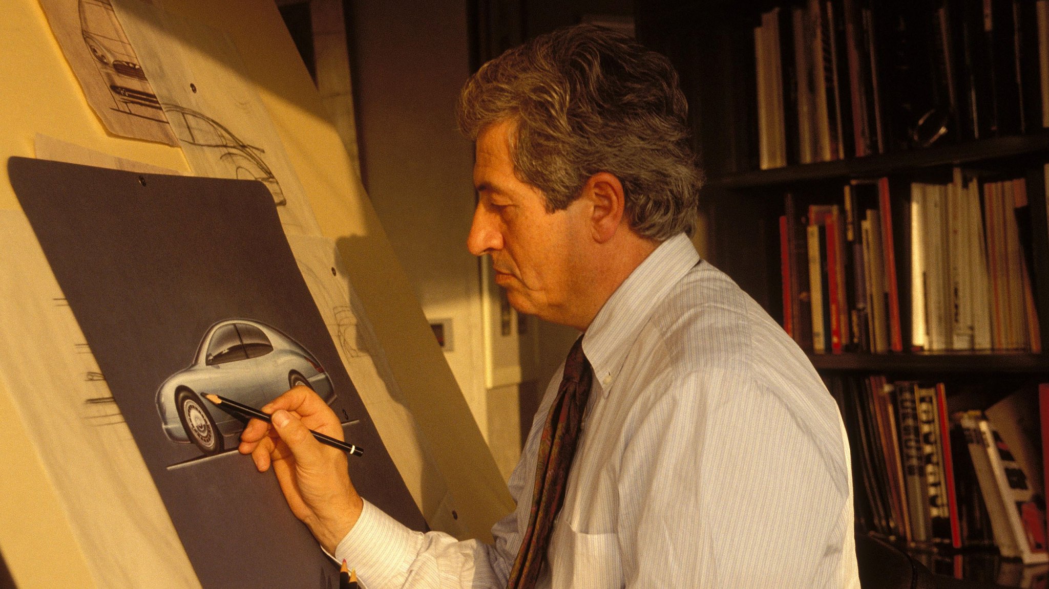 A photo of Giorgetto Giugiaro sketching the Bugatti EB112 concept in 1993.