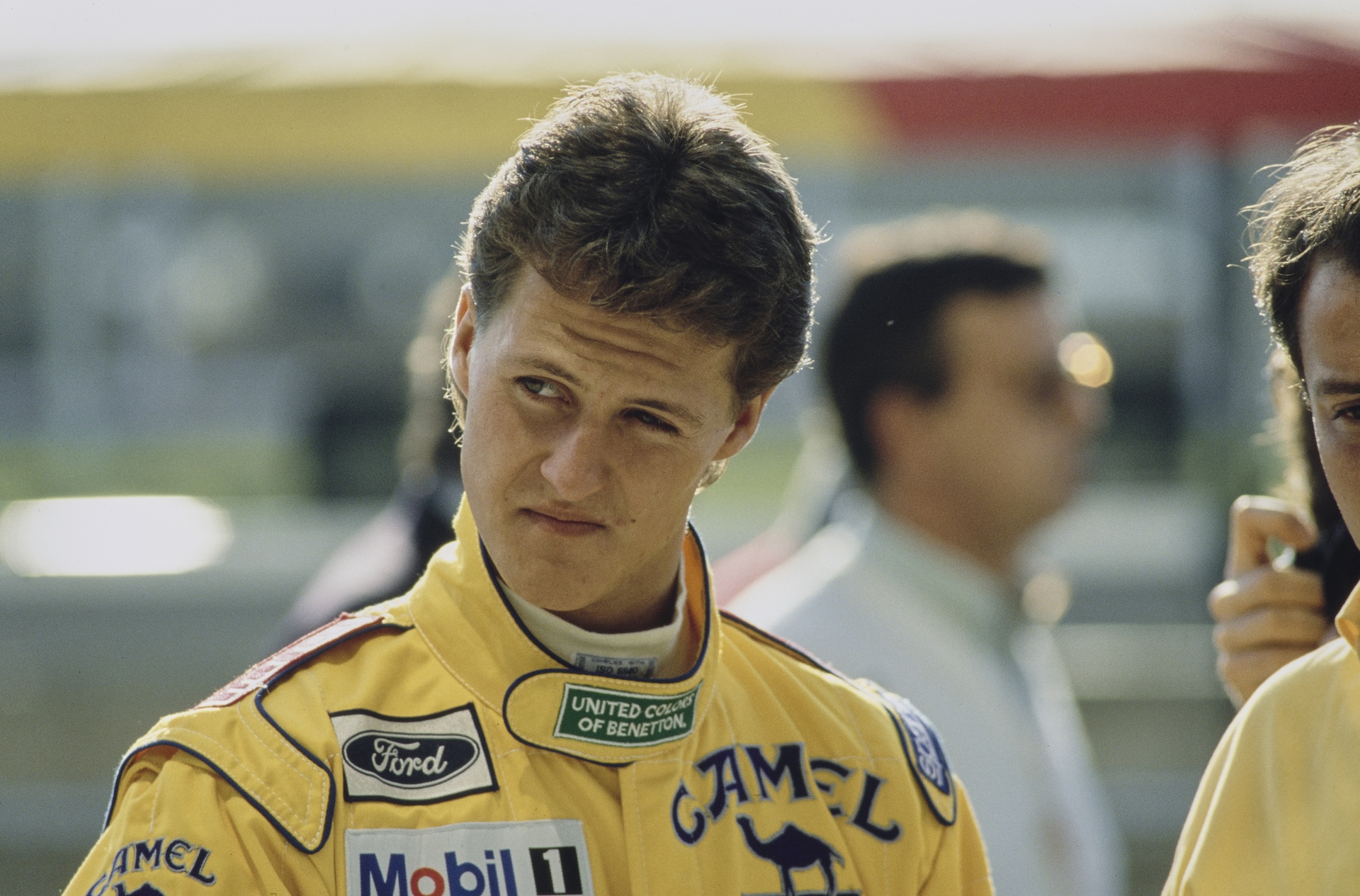 German racing driver Michael Schumacher, wearing his yellow coveralls ahead of the Spanish Grand Prix, held at the Circuit de Catalunya in Montmelo, Catalonia, Spain, 29th September 1991. Schumacher finished the race in third place, driving a Benetton B191 with a Ford HBA 5 3 5 V8 engine for the Camel Benetton Ford Team. (Photo by Bongarts/Getty Images)