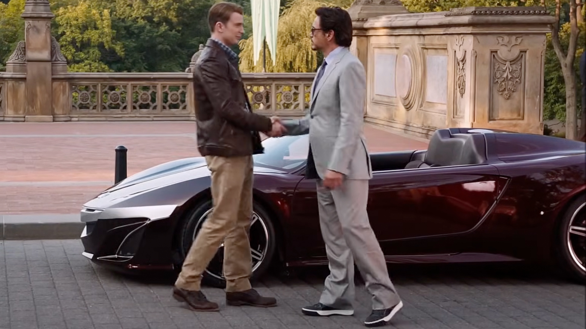 Captain America and Tony Stark shake hands at the end of the 2012 Avengers movie in front of an Acura NSX.