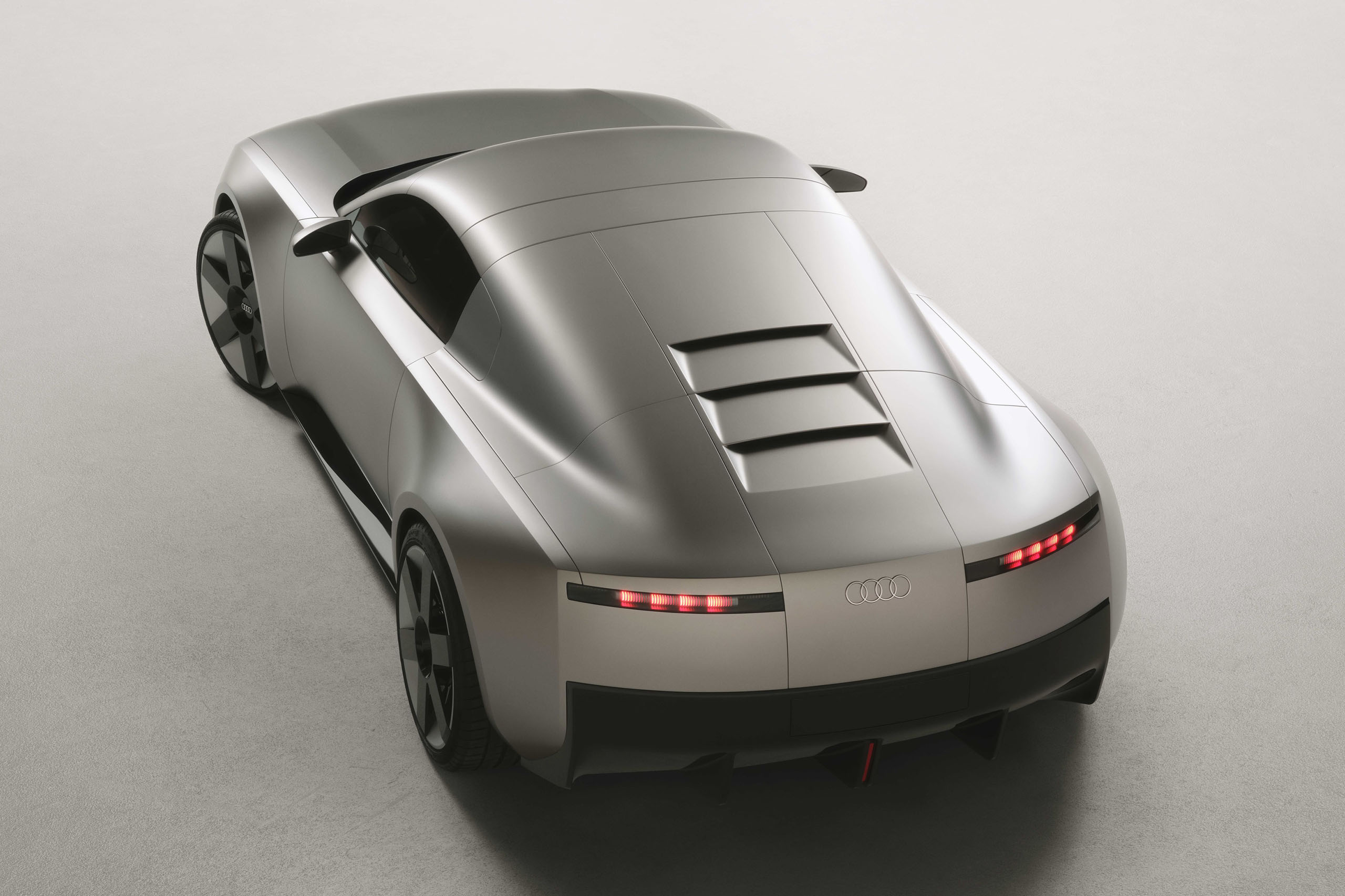 Static studio shot, exterior, rear three-quarter view, top-down perspective