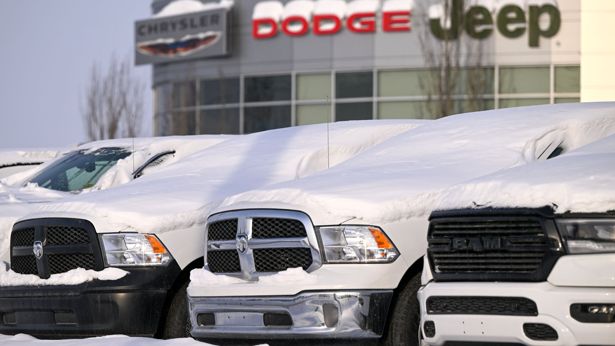 EDMONTON, CANADA - FEBRUARY 02: Dodge and RAM vehicles covered in snow seen outside a dealership in Edmonton, AB, Canada, on February 02, 2025. In response to U.S. tariffs on Canadian imports and oil, Prime Minister Justin Trudeau announced retaliatory countermeasures on American goods. (Photo by Artur Widak/NurPhoto via Getty Images)
