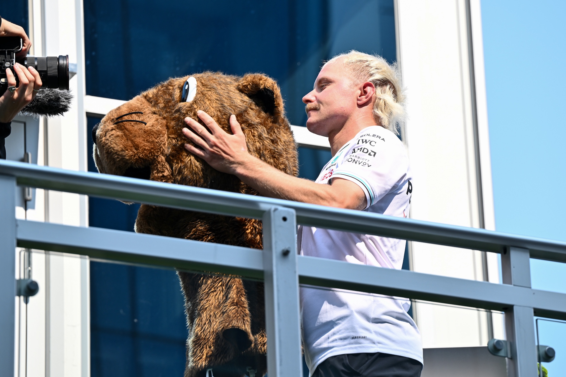 MONTREAL, QUEBEC - JUNE 12: Valtteri Bottas of Finland and Mercedes AMG Petronas F1 Team puts on the mask of Vroum in the Paddock during previews ahead of the F1 Grand Prix of Canada at Circuit Gilles-Villeneuve on June 12, 2025 in Montreal, Quebec. (Photo by Minas Panagiotakis/Getty Images)