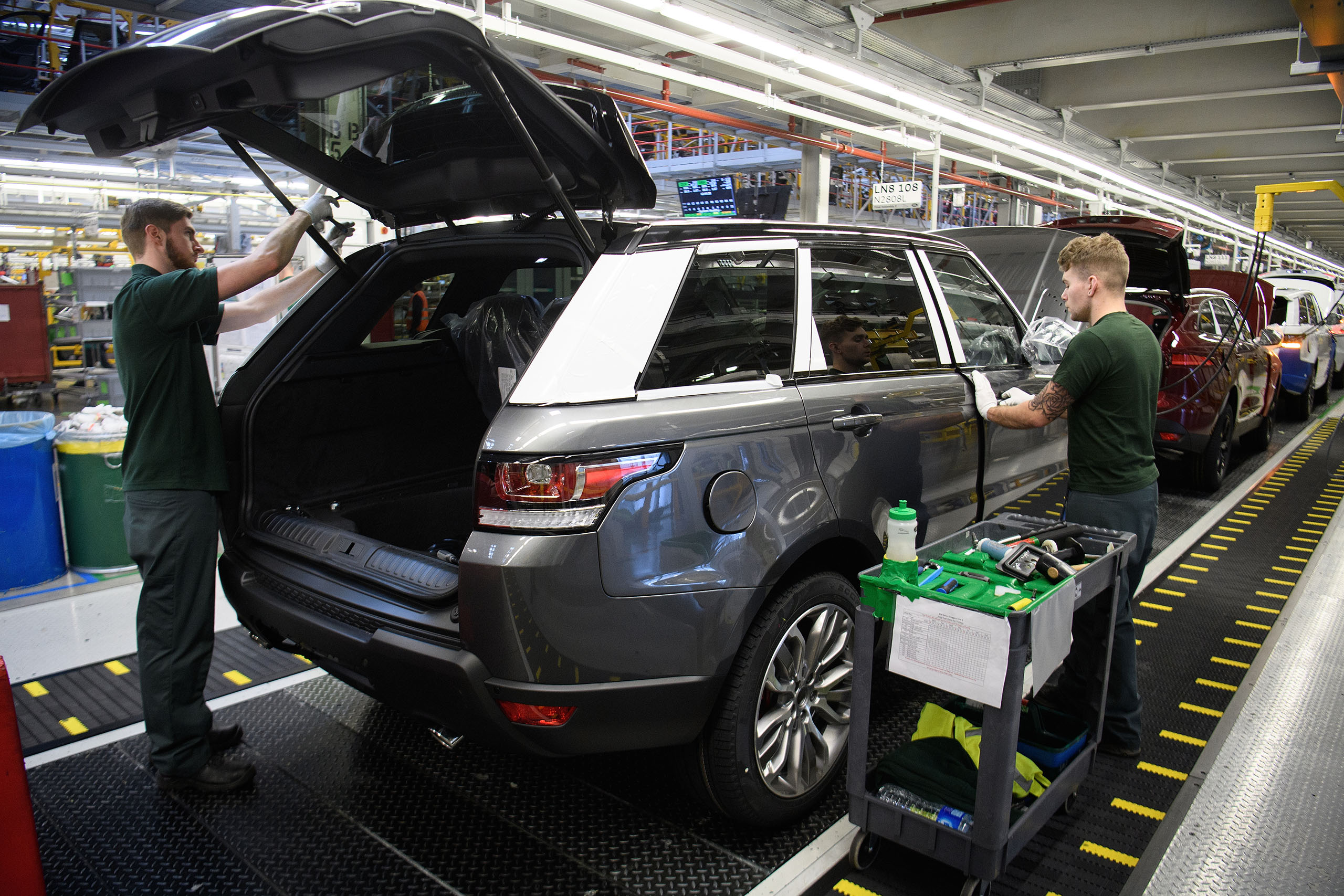 SOLIHULL, ENGLAND - MARCH 06: Doors are fitted and checked during production at the Jaguar Land Rover factory on March 1, 2017 in Solihull, England. The company has pledged it's 'heart and soul' to production in the UK after producing the new "Velar" model for global sale, at their Solihull factory. (Photo by Leon Neal/Getty Images)