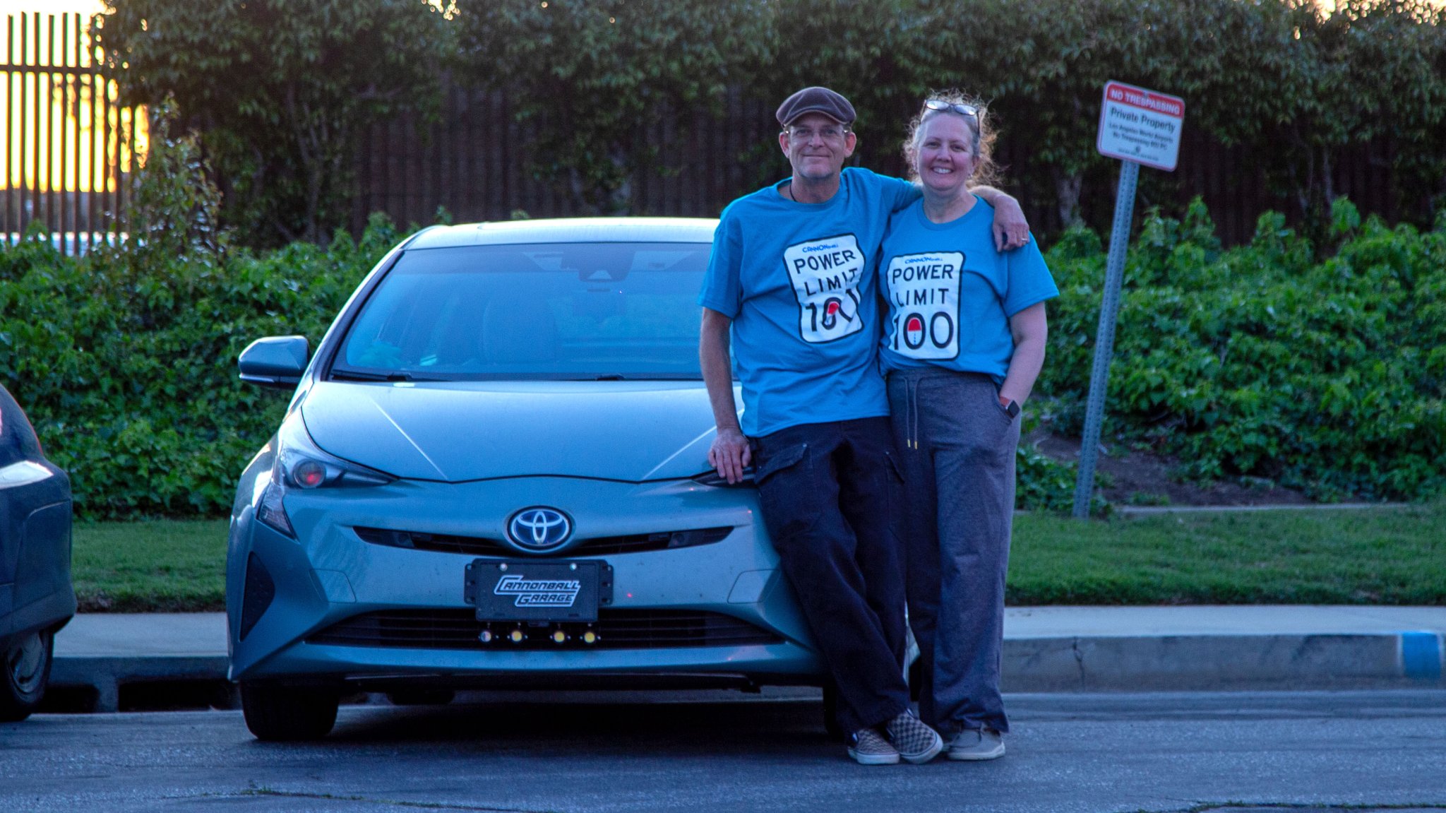 Photo of Jay and Gypsy Roberts posing with their Prius used to complete the Cannonball Run