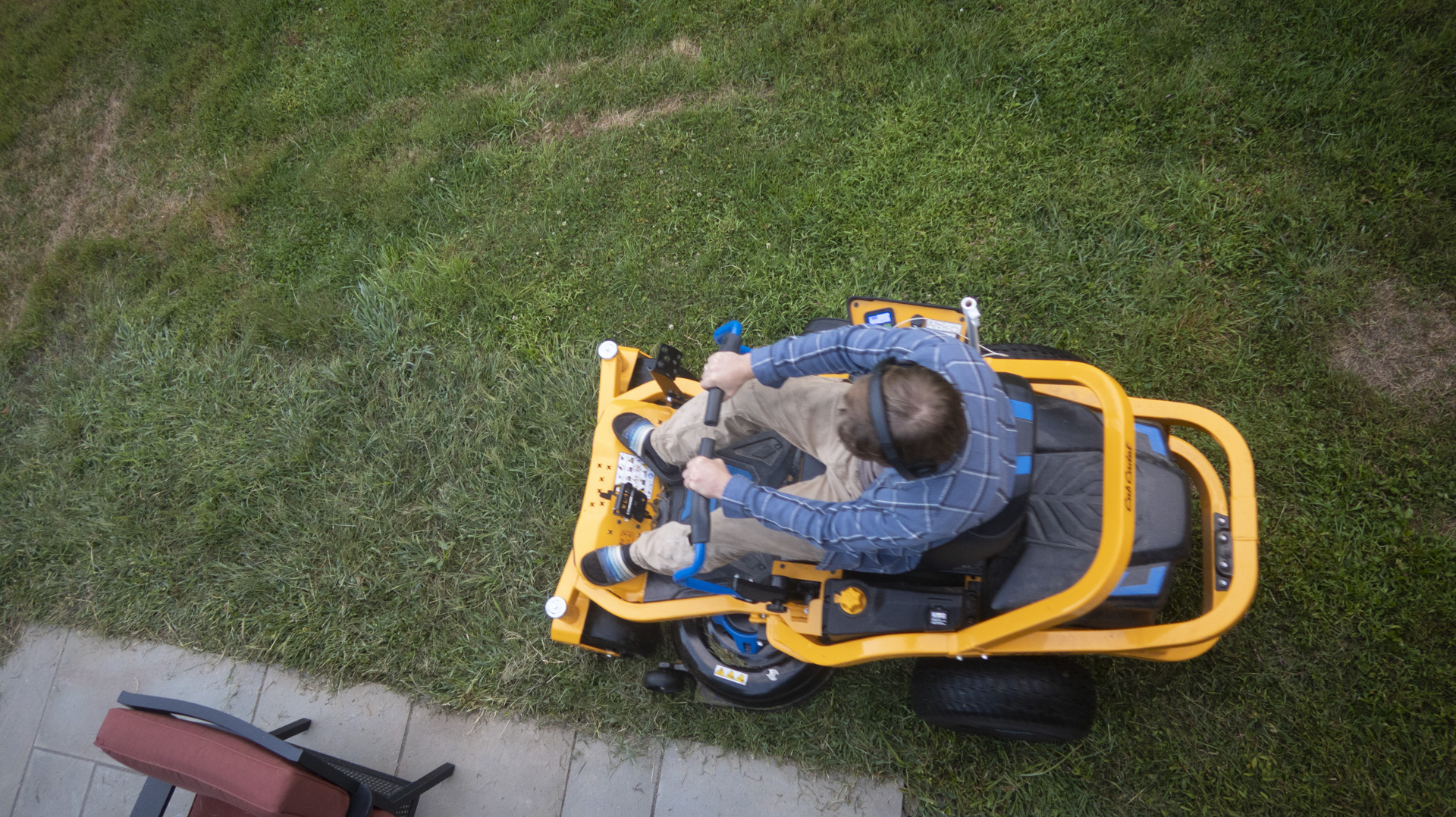 Lawn mowing on a ride-on mower, as seen from above.