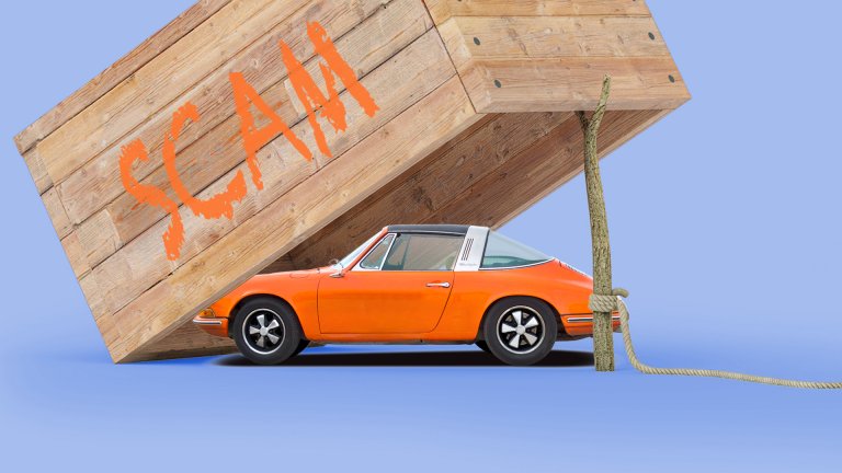 A Porsche under a box propped up by a stick which is held by a string. On the box, the word "SCAM" is written in orange paint.
