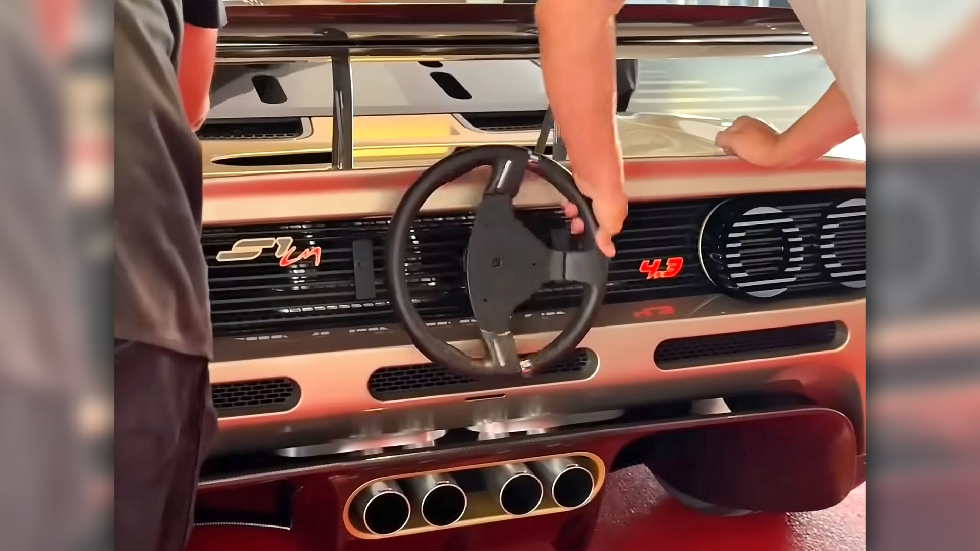 Gordon Murray S1 LM being steered into museum with rear-mounted steering wheel.