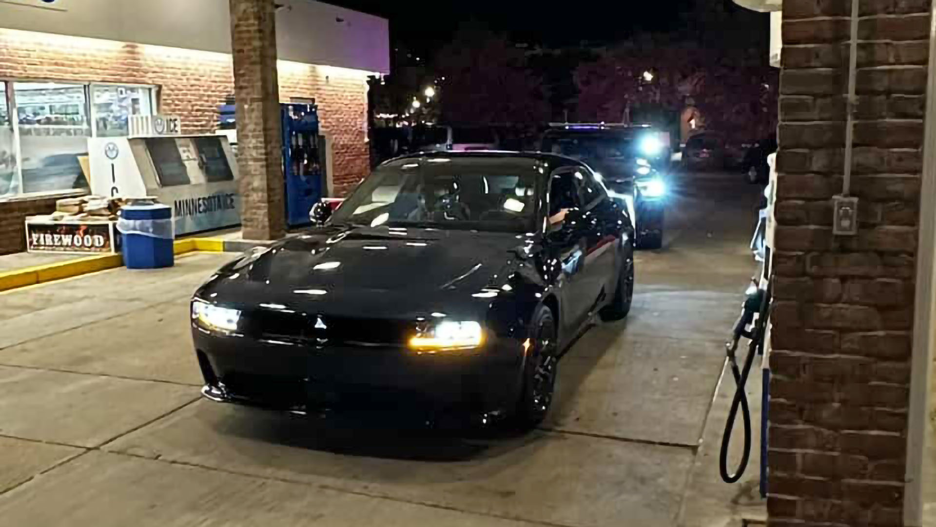 Picture of Dodge Charger EV pulled over at gas station for loud exhaust.