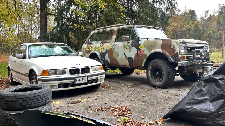 An old BMW and an International Scout in various stages of repair.