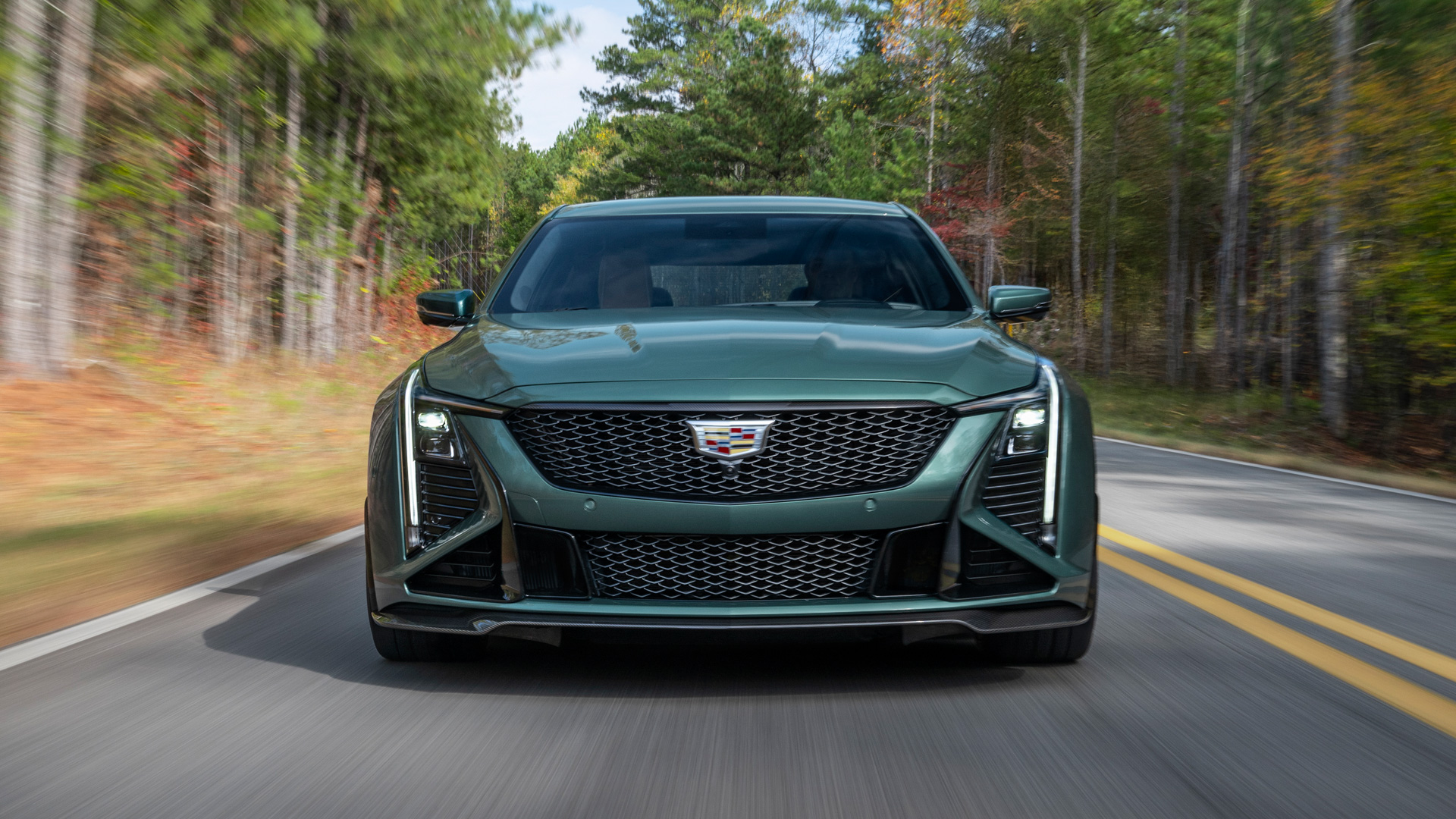 Front view of the 2026 Cadillac CT5-V Blackwing Precision Package in Typhoon Metallic driving on a road.