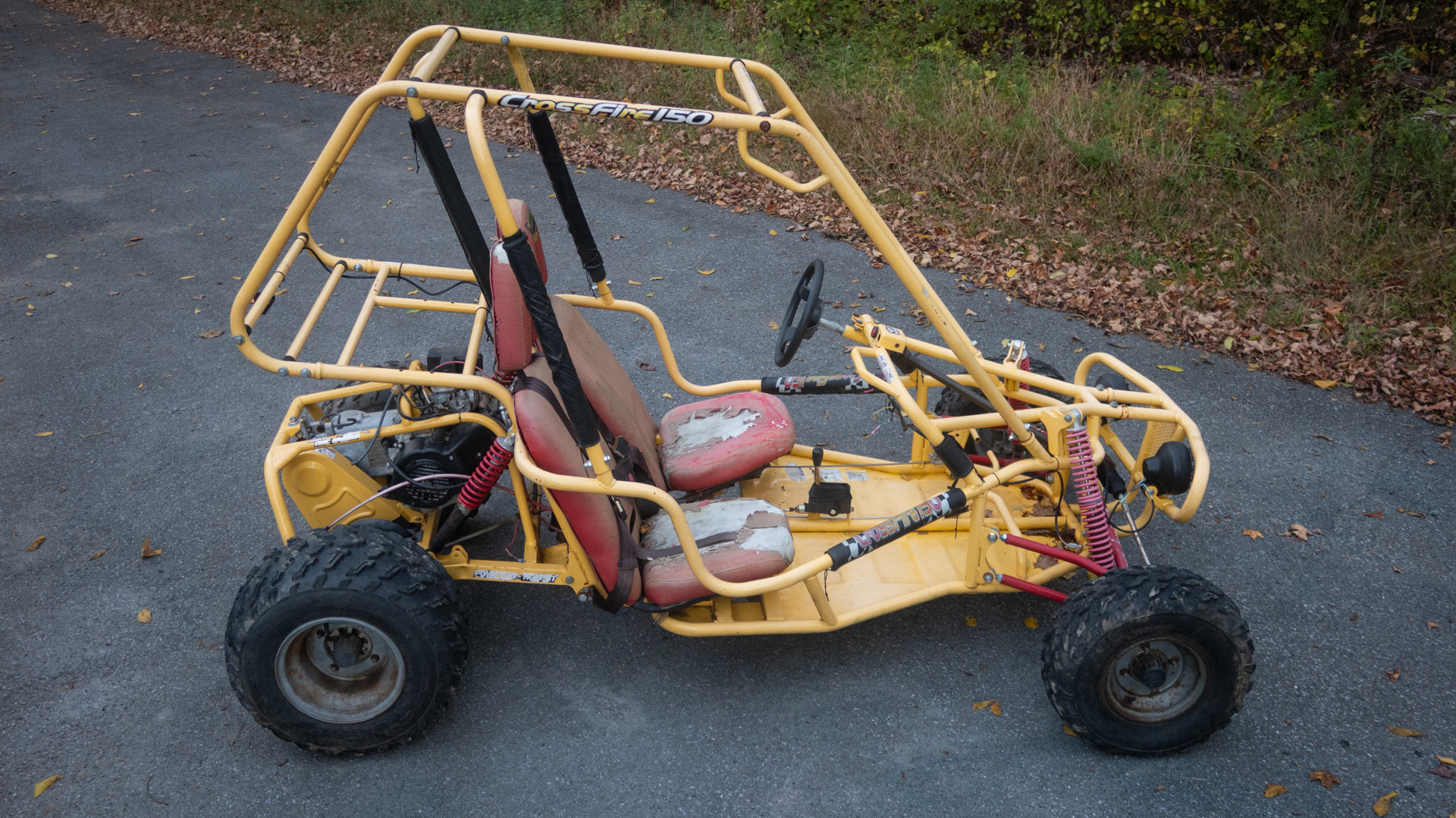 Tomberlin Crossfire 150, yellow go-kart from the side.