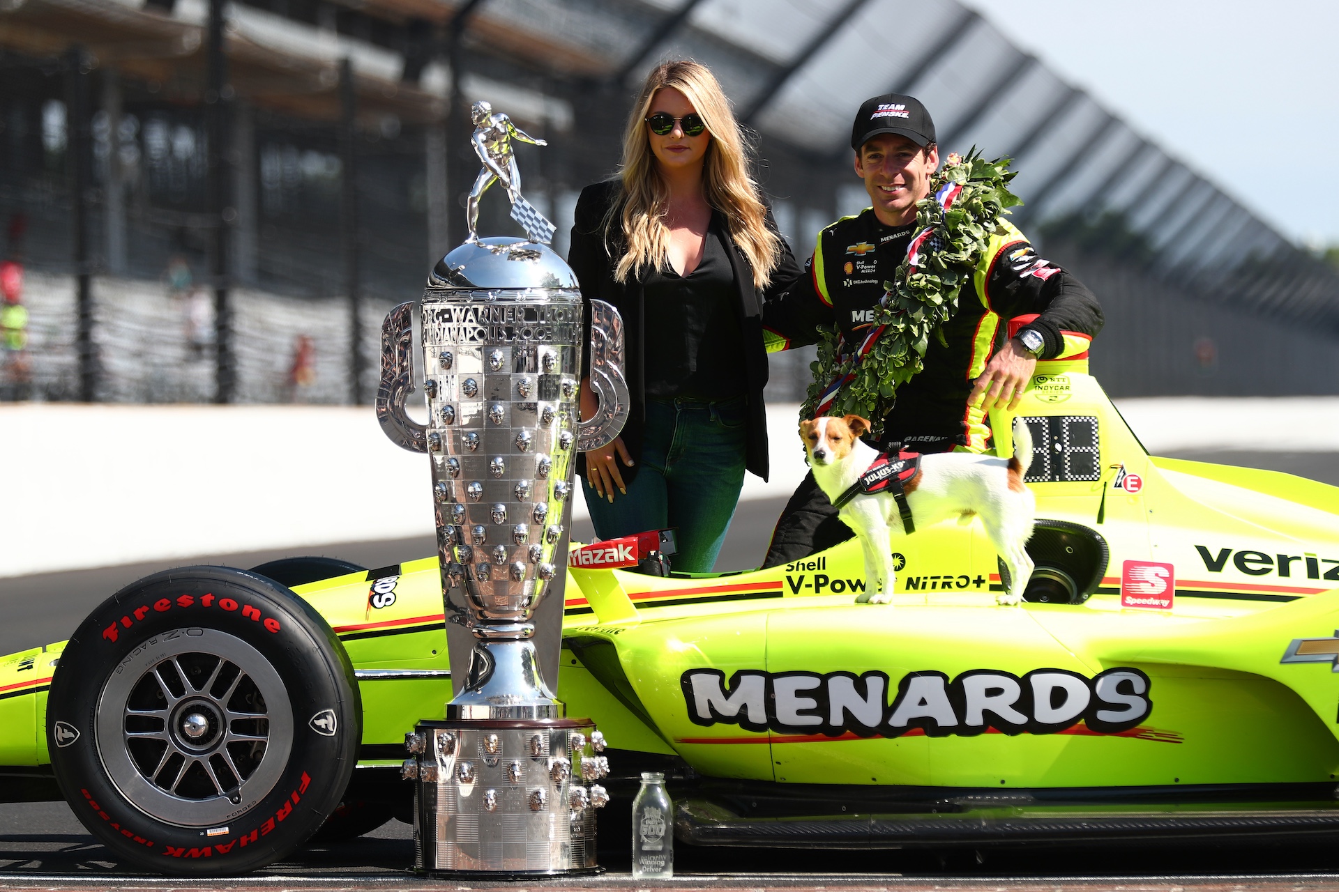 INDIANAPOLIS, INDIANA - MAY 27: Simon Pagenaud of France, driver of the #22 Team Penske Chevrolet poses with his Wife Hailey McDermott during the Winner's Portraits session after the 103rd running of the Indianapolis 500 at Indianapolis Motor Speedway on May 27, 2019 in Indianapolis, Indiana. (Photo by Clive Rose/Getty Images)