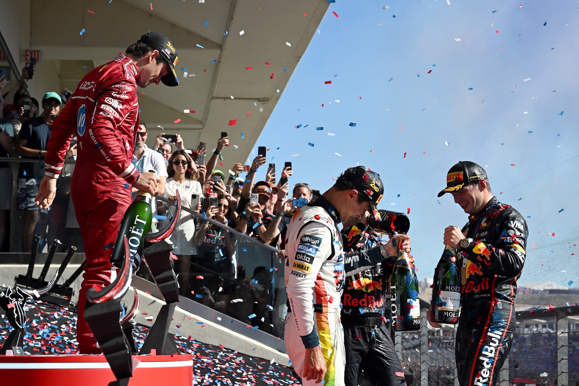 AUSTIN, TEXAS - OCTOBER 19: Race winner Max Verstappen of the Netherlands and Oracle Red Bull Racing Second placed Lando Norris of Great Britain and McLaren and Third placed Charles Leclerc of Monaco and Scuderia Ferrari on the podium during the F1 Grand Prix of United States at Circuit of The Americas on October 19, 2025 in Austin, Texas. (Photo by Mark Sutton - Formula 1/Formula 1 via Getty Images)