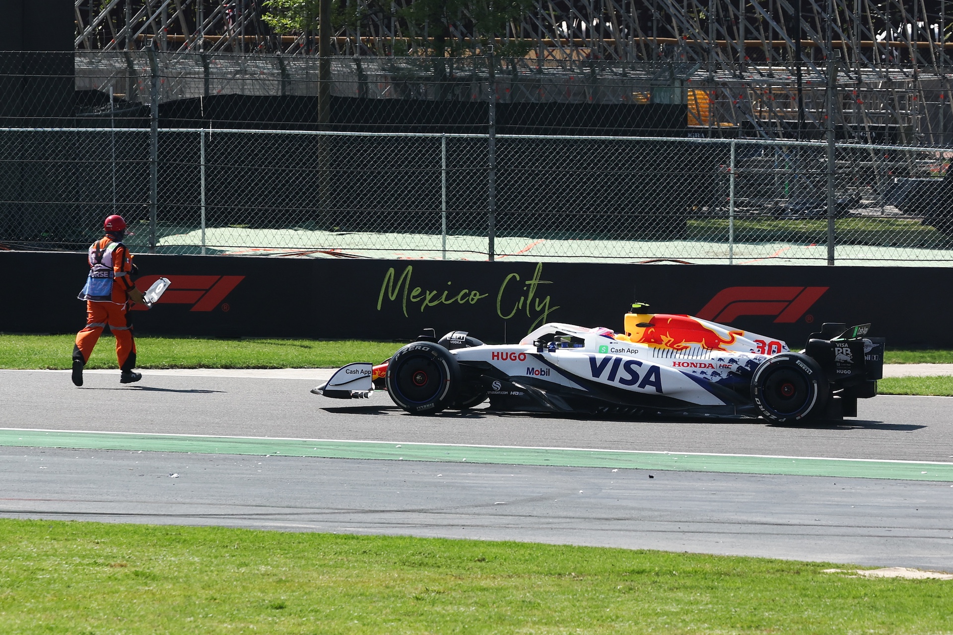 A marshal on track and Liam Lawson of Racing Bulls during the Formula 1 Grand Prix of Mexico City at Autódromo Hermanos Rodríguez in Mexico City, Mexico on October 26, 2025. (Photo by Jakub Porzycki/NurPhoto)