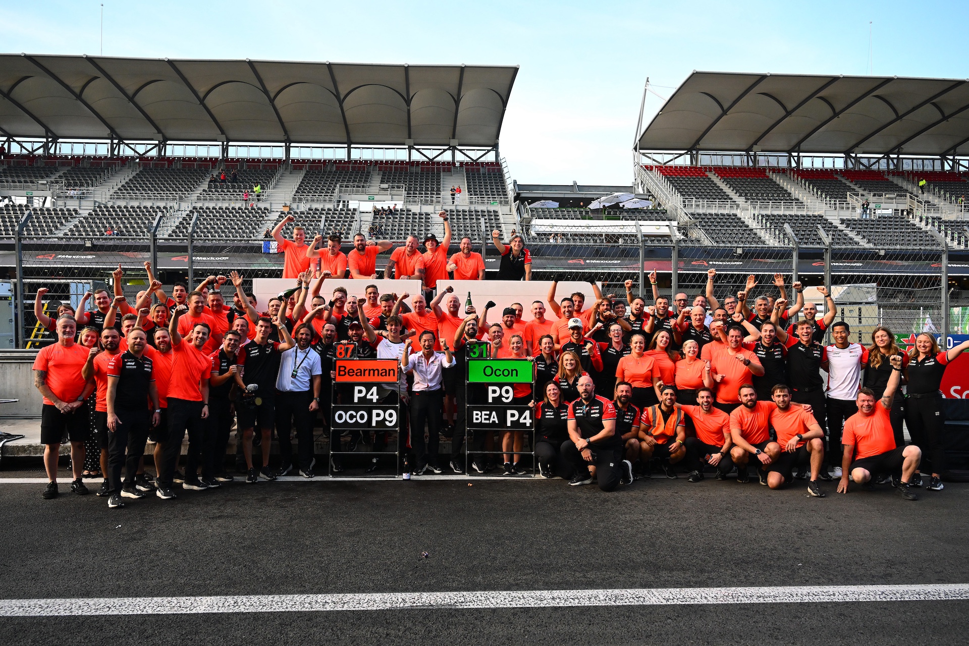 MEXICO CITY, MEXICO - OCTOBER 26: Fourth placed Oliver Bearman of Great Britain and Haas F1 Ayao Komatsu, Team Principal of Haas F1 Ninth placed Esteban Ocon of France and Haas F1 and the Haas F1 team celebrate during the F1 Grand Prix of Mexico at Autodromo Hermanos Rodriguez on October 26, 2025 in Mexico City, Mexico. (Photo by Mark Sutton - Formula 1/Formula 1 via Getty Images)