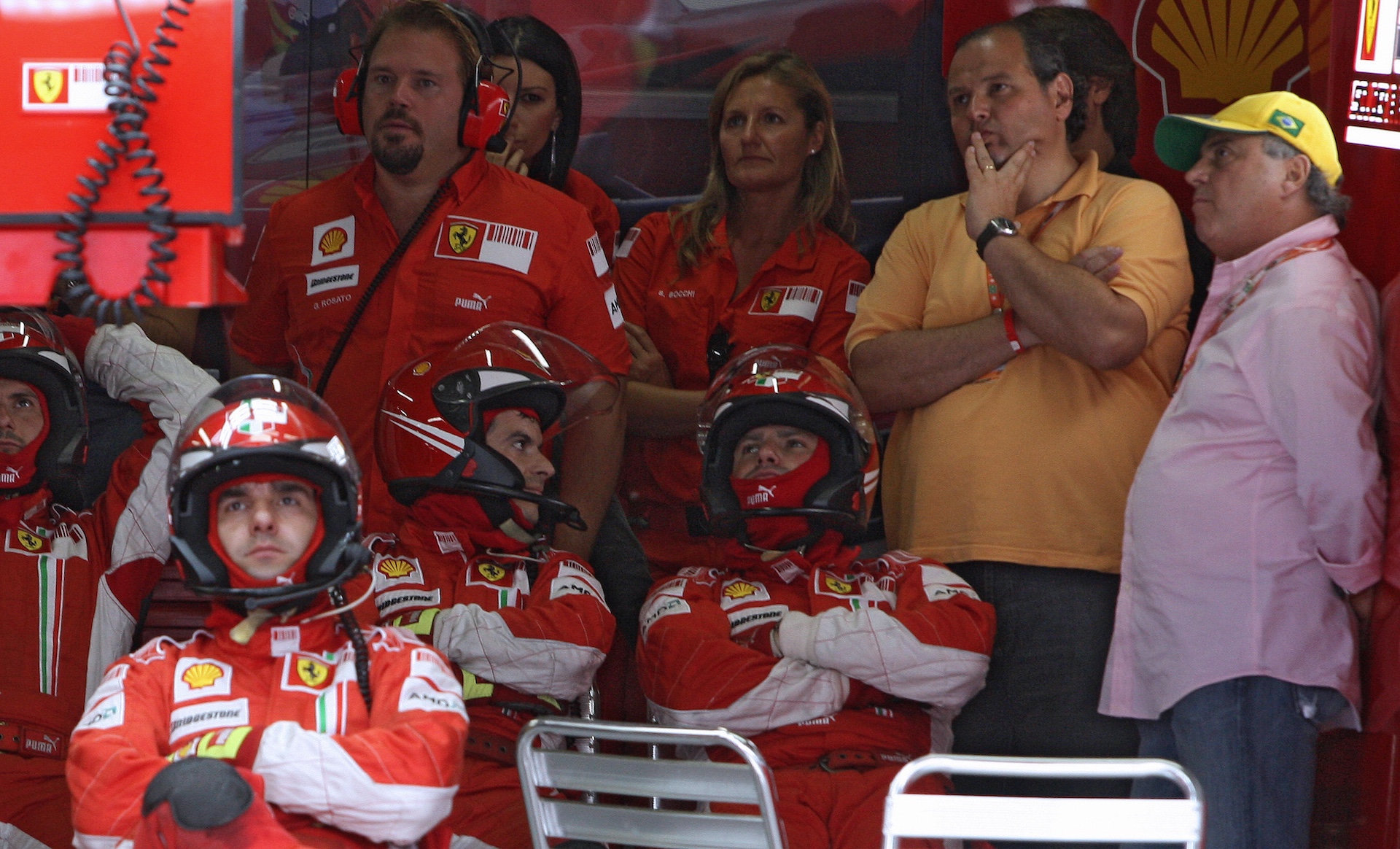 The Formula One mechanics of Ferrari observe the Brazilian Gran Prix in a screen, at the Interlagos racetrack in Sao Paulo, Brazil, on November 2, 2008. Brazilian Felipe Massa of Ferrari won the race and British Lewis Hamilton was crowned Formula One champion after finishing fifth in the race. AFP PHOTO/VANDERLEI ALMEIDA/POOL (Photo credit should read VANDERLEI ALMEIDA/AFP via Getty Images)