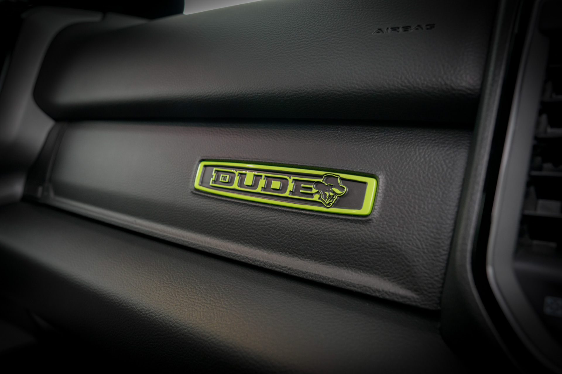 Inside the cabin of The Dude concept, a custom designed instrument panel badge features The Dude logo in bright green.
