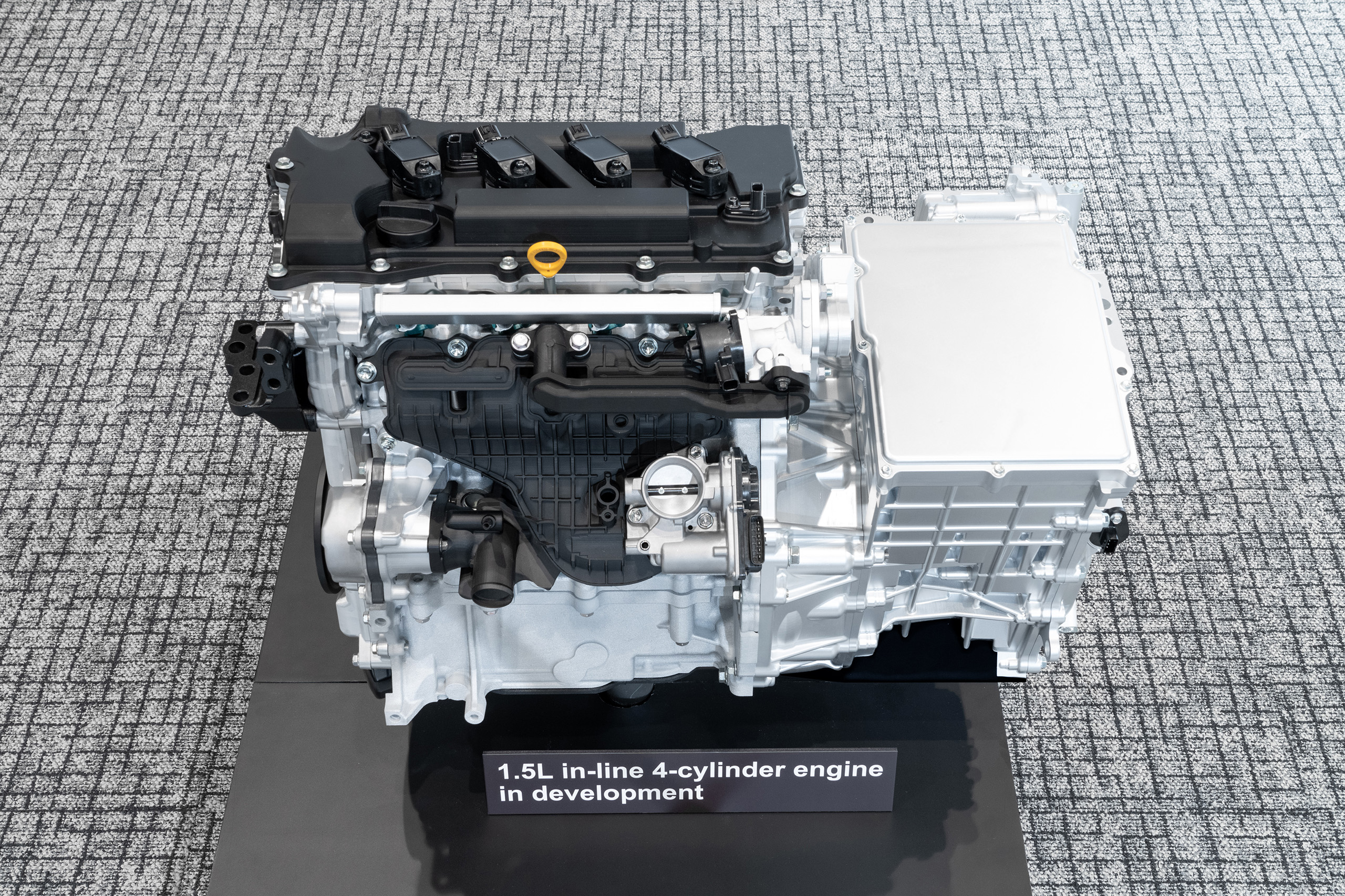 Toyota's next-generation 1.5-liter, four-cylinder engine and hybrid system photographed in 2024 presentation.