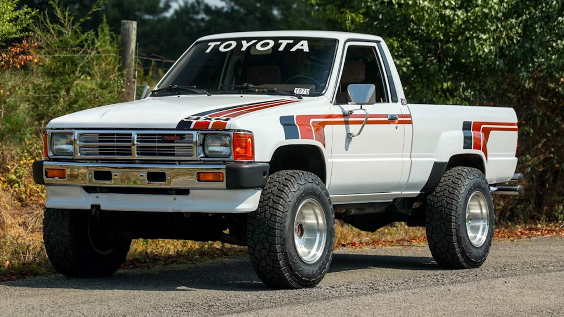 Toyota pickup truck in white with graphic stripes.