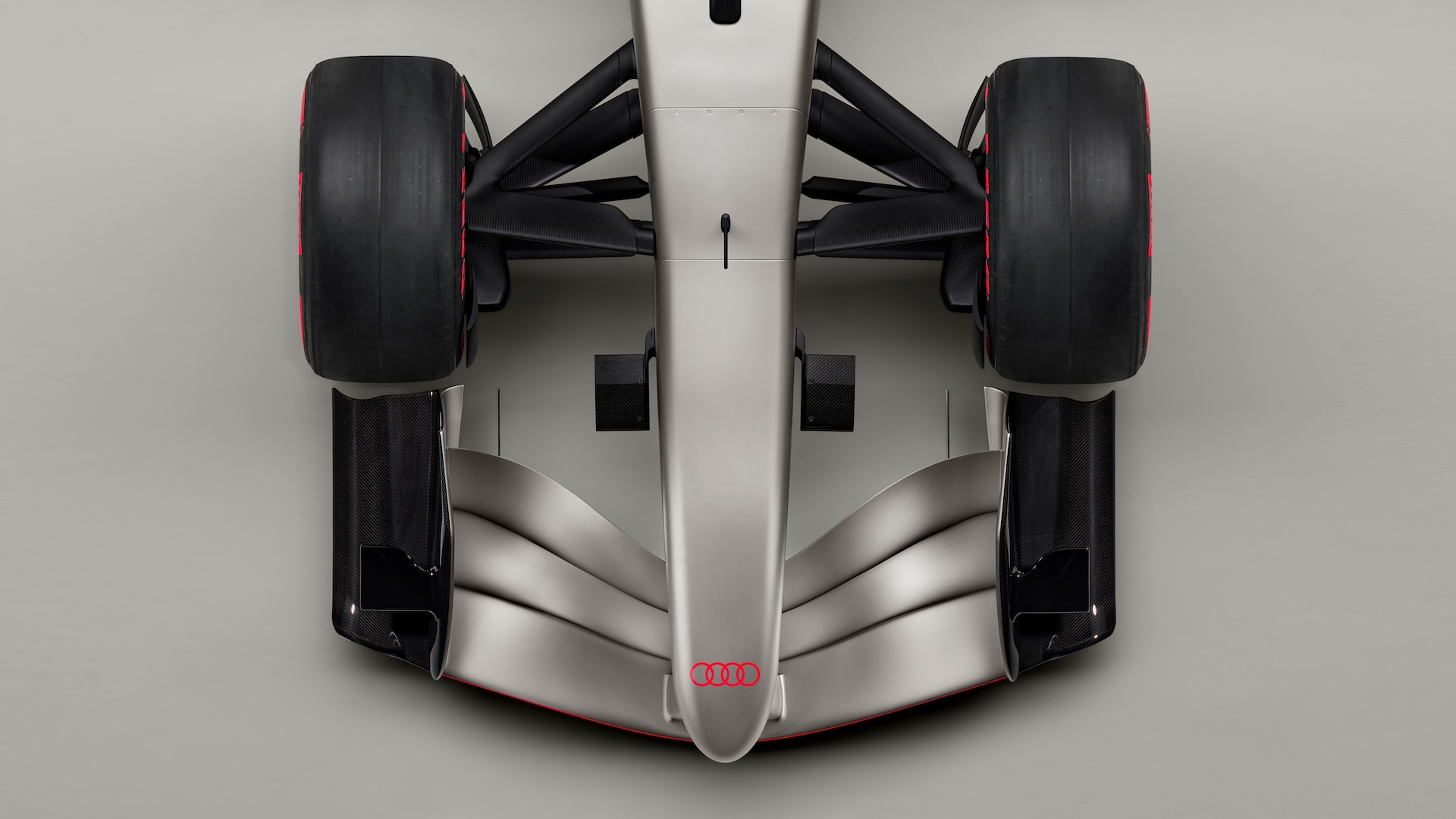 Indoor studio shot, exterior, bird’s-eye view, detail of wheel suspension, nose, and front wing