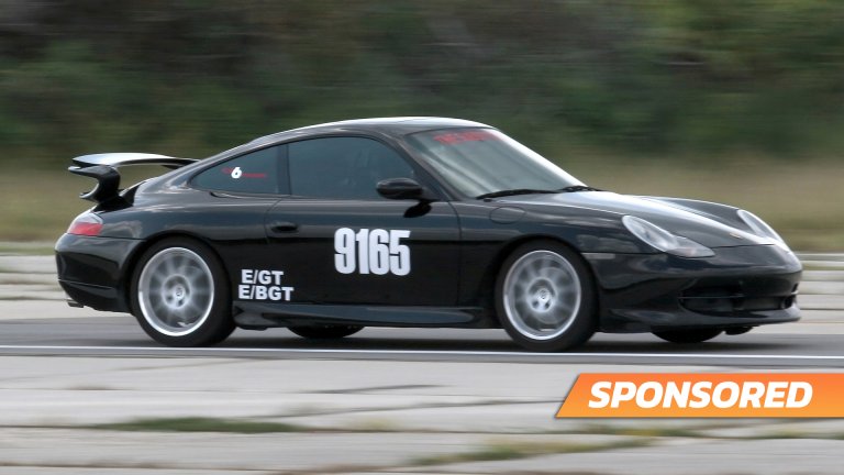 Porsche 996 speed-record car zooming from camera left to right.