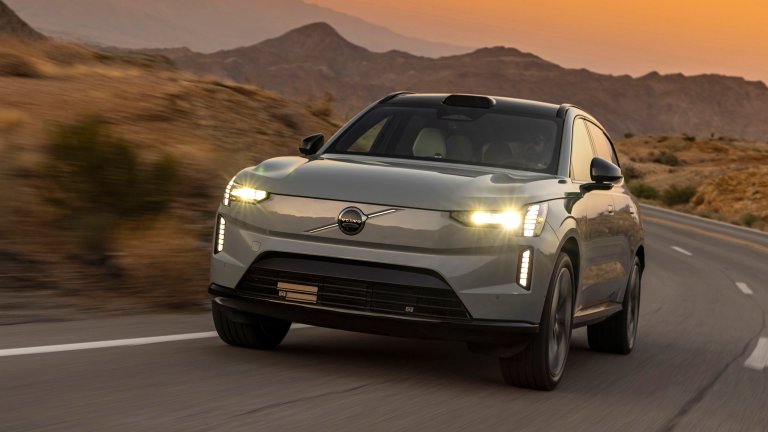 Volvo EX90 driving in desert at sunset