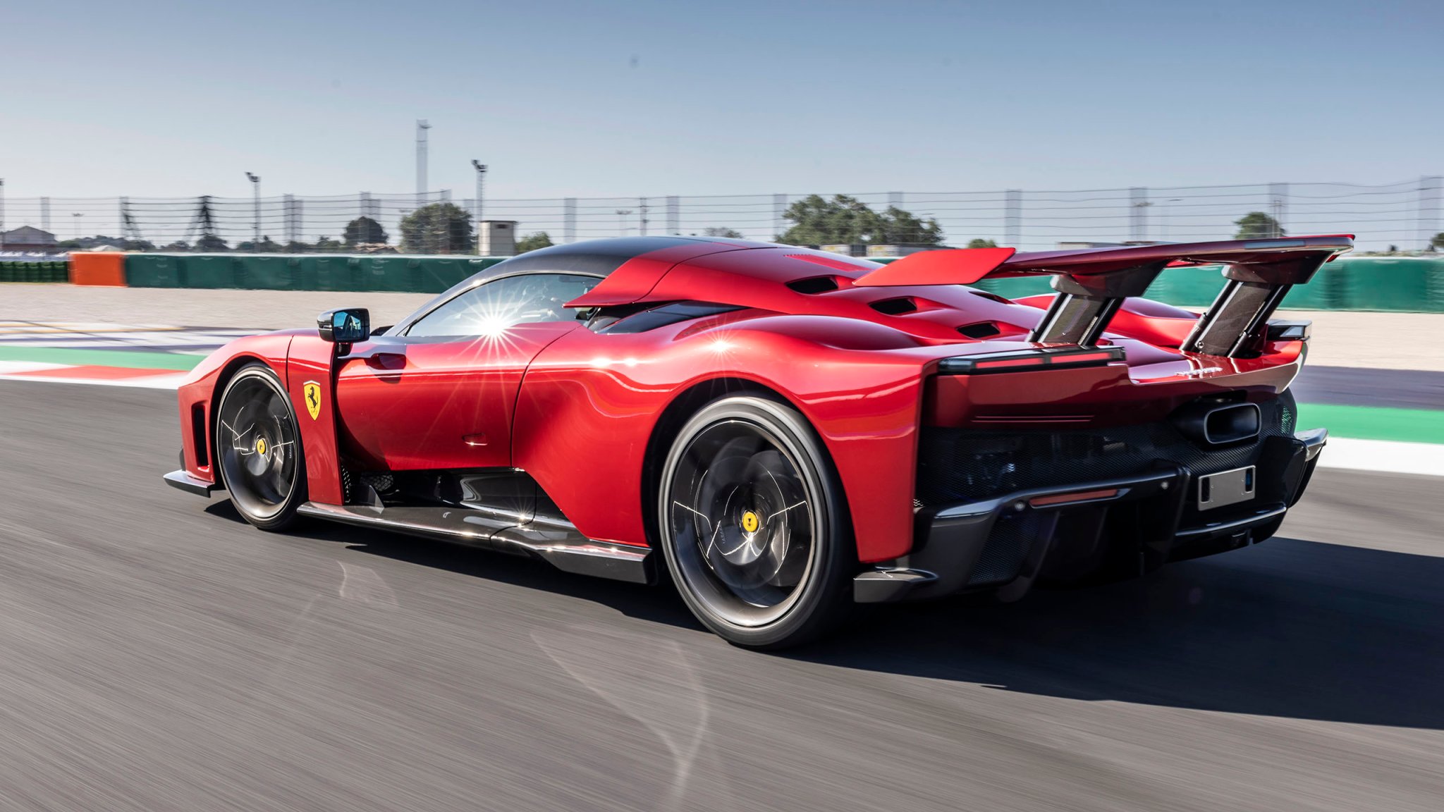 Photo of Ferrari F80 on track, rear three-quarter view.