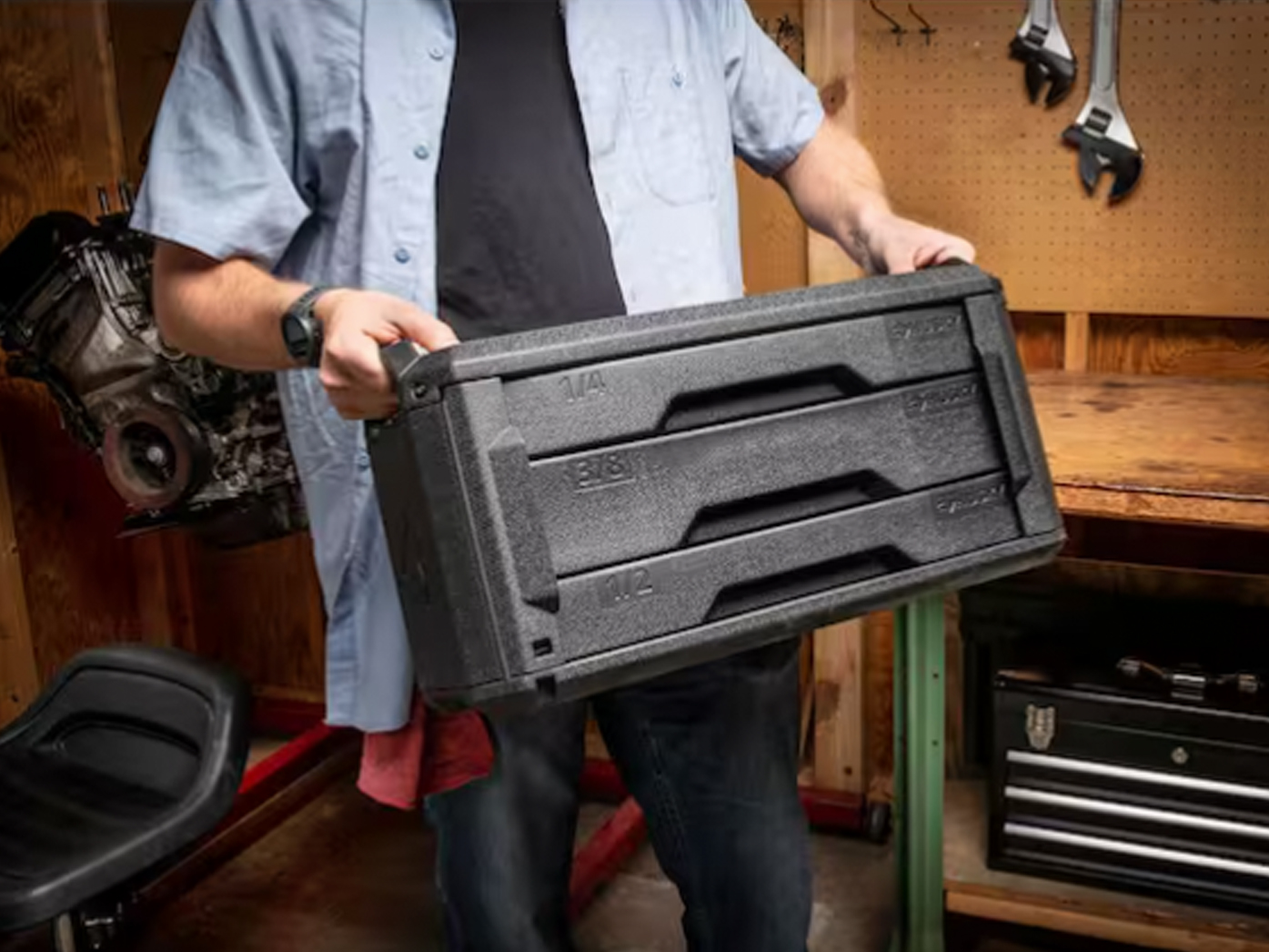 Guy carrying a tool kit.