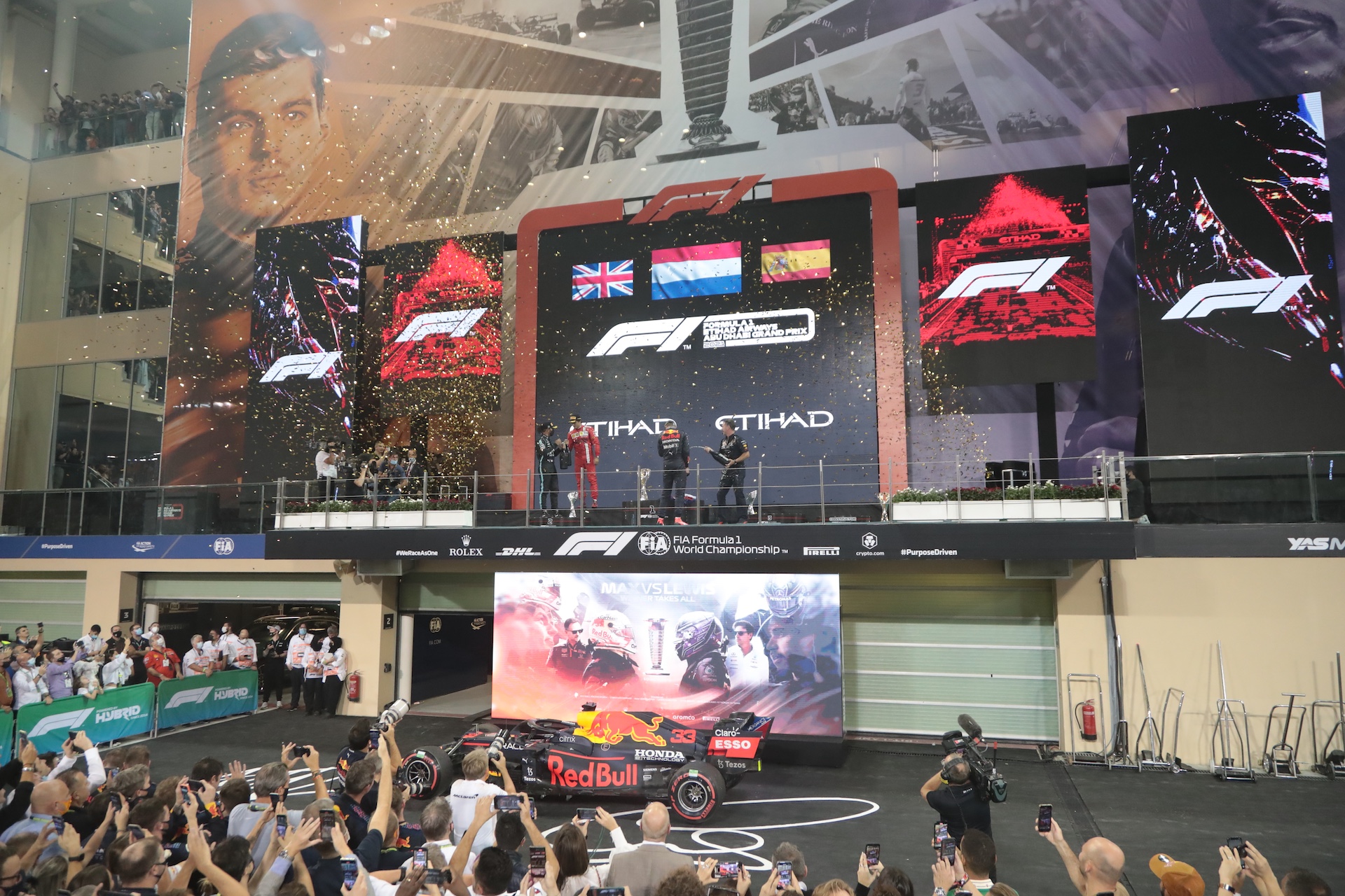 ABU DHABI, UNITED ARAB EMIRATES - DECEMBER 12: Celebration with Max Verstappen after winning the F1 World Championship Title, Podium, (L-R) Lewis Hamilton, Max Verstappen, Carlos Sainz Jr. seen during the Grand Prix Formula 1 of Abu Dhabi, at Yas Marina Circuit on December 12, 2021 in Abu Dhabi, United Arab Emirates. (Photo by Steve Domenjoz ATPImages/Getty Images)