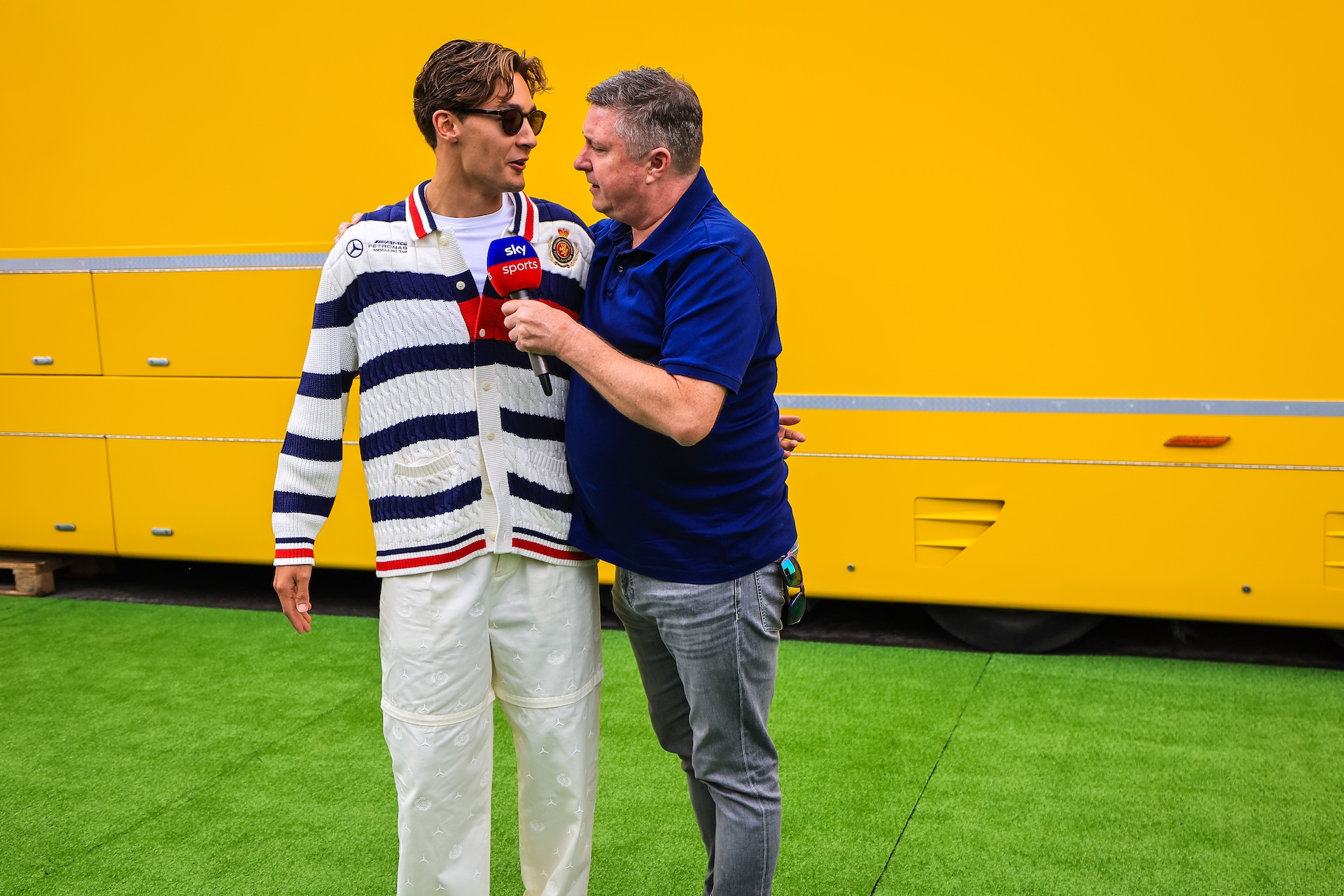 BARCELONA, SPAIN - JUNE 20: George Russell of Great Britain and Mercedes being interviewed by David Croft in the paddock during previews ahead of the F1 Grand Prix of Spain at Circuit de Barcelona-Catalunya on June 20, 2024 in Barcelona, Spain. (Photo by Kym Illman/Getty Images)
