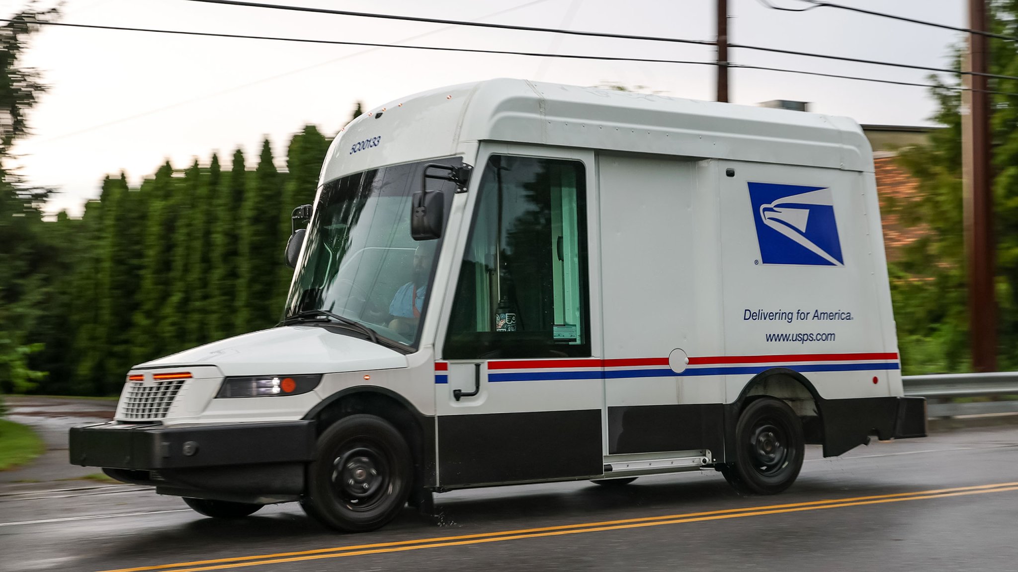 A United States Postal Service (USPS) worker drives an Oshkosh Next Generation Delivery Vehicle (NGDV) in Williamsport, Pennsylvania.