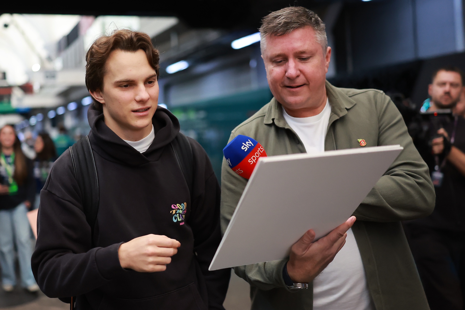 SAO PAULO, BRAZIL - NOVEMBER 06: Oscar Piastri of Australia and McLaren is interviewed by David Croft as he arrives in the Paddock during previews ahead of the F1 Grand Prix of Brazil at Autodromo Jose Carlos Pace on November 06, 2025 in Sao Paulo, Brazil. (Photo by Hector Vivas/Getty Images)