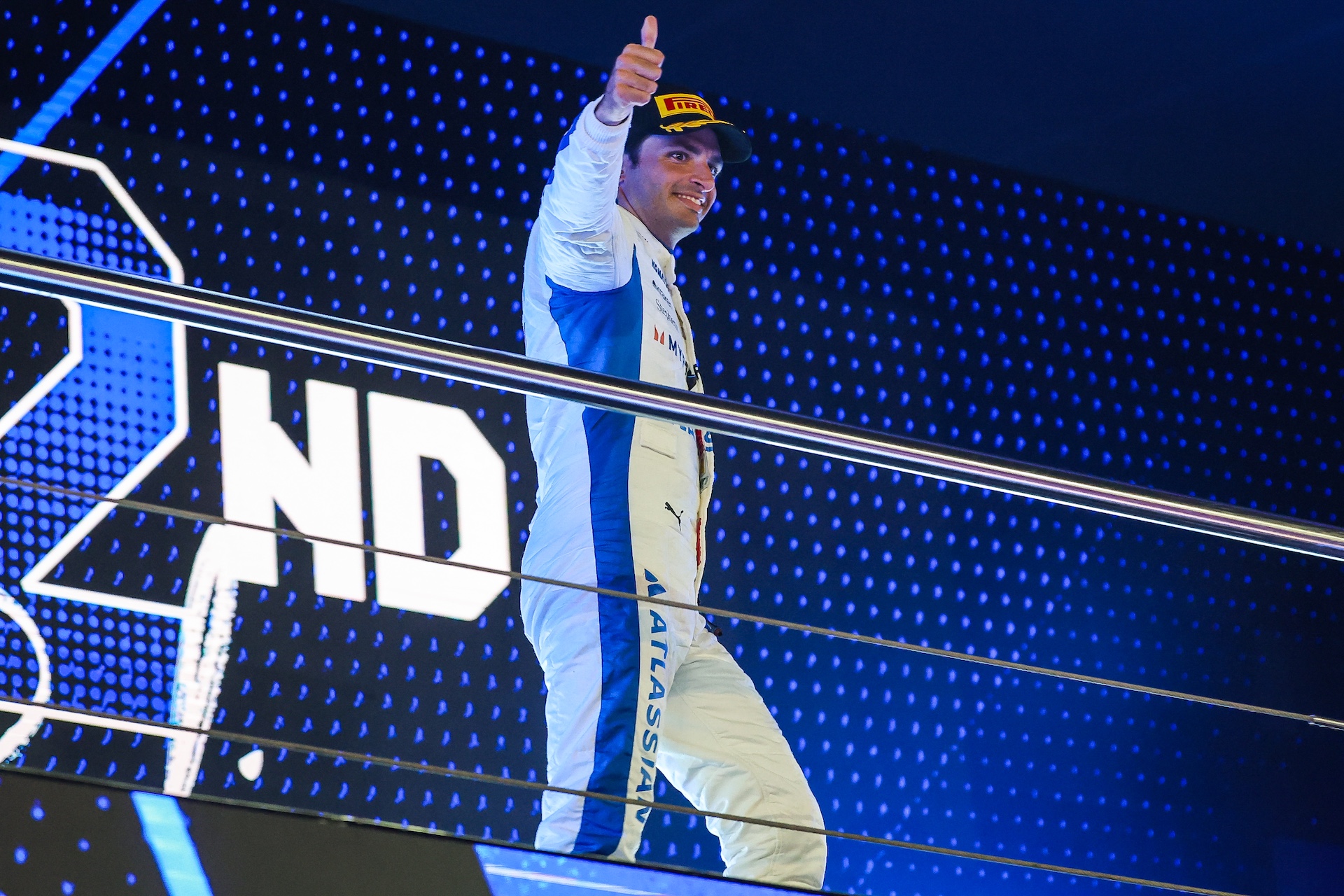 LUSAIL CITY, QATAR - NOVEMBER 30: Carlos Sainz of Spain and Williams gives a thumbs up to fans on the podium during the F1 Grand Prix of Qatar at Lusail International Circuit on November 30, 2025 in Lusail City, Qatar. (Photo by Kym Illman/Getty Images)