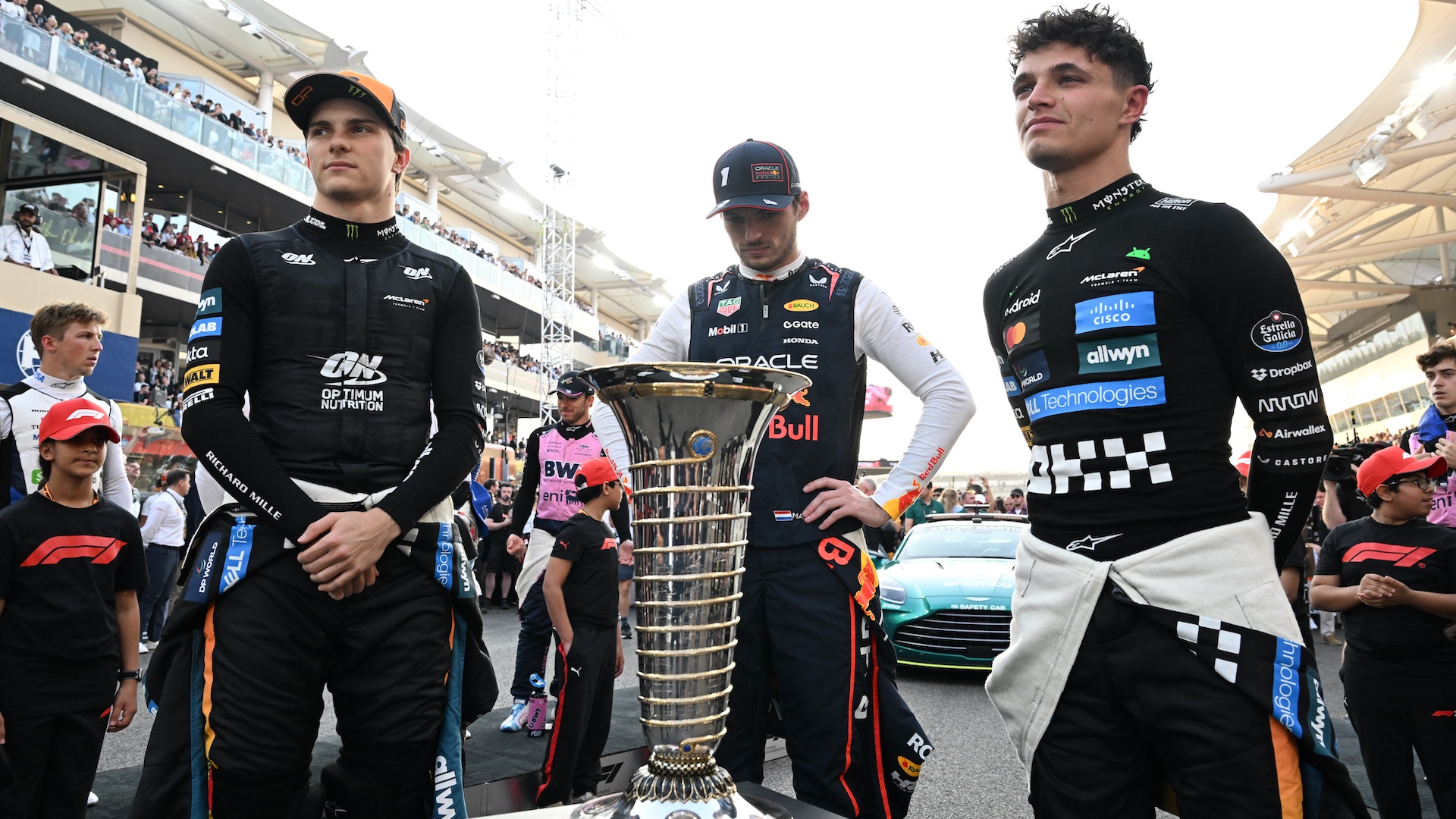 ABU DHABI, UNITED ARAB EMIRATES - DECEMBER 07: F1 World Drivers Championship contenders Lando Norris of Great Britain and McLaren Max Verstappen of the Netherlands and Oracle Red Bull Racing and Oscar Piastri of Australia and McLaren on the grid during the F1 Grand Prix of Abu Dhabi at Yas Marina Circuit on December 07, 2025 in Abu Dhabi, United Arab Emirates. (Photo by Mark Sutton - Formula 1/Formula 1 via Getty Images)