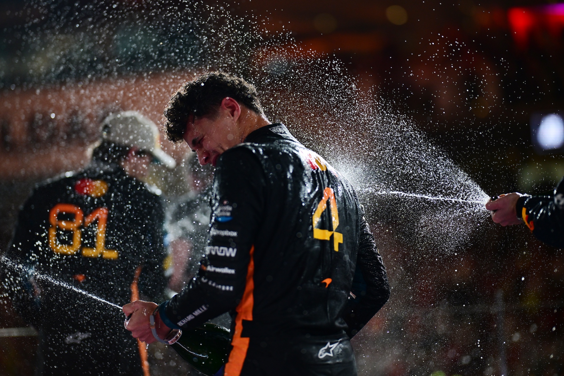 ABU DHABI, UNITED ARAB EMIRATES - DECEMBER 07: 2025 F1 World Drivers Champion and Third placed Lando Norris of Great Britain and McLaren celebrates on the podium with Champagne during the F1 Grand Prix of Abu Dhabi at Yas Marina Circuit on December 07, 2025 in Abu Dhabi, United Arab Emirates. (Photo by Mario Renzi - Formula 1/Formula 1 via Getty Images)