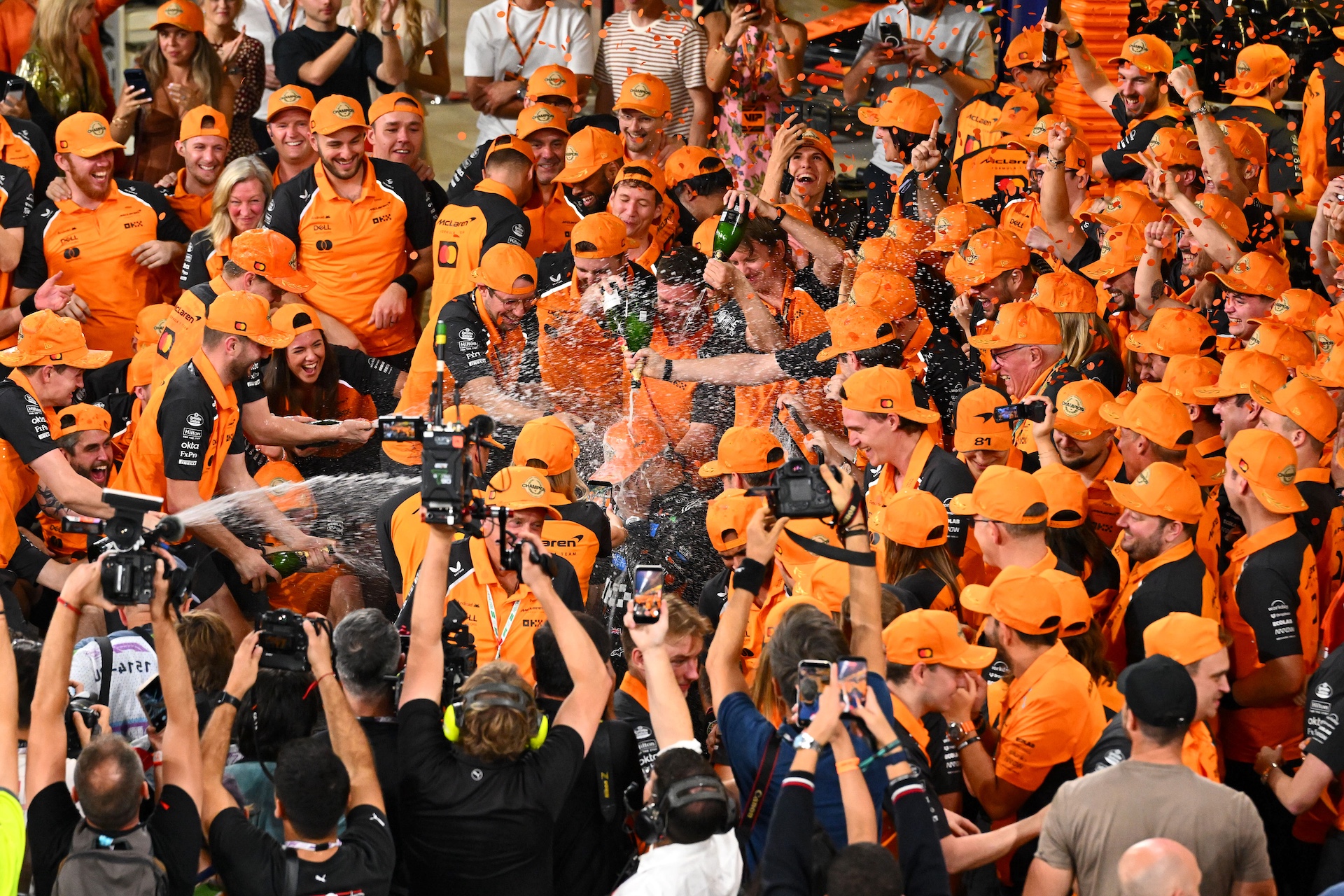 ABU DHABI, UNITED ARAB EMIRATES - DECEMBER 07: 2025 F1 World Drivers Champion Lando Norris of Great Britain and McLaren celebrates with the McLaren team during the F1 Grand Prix of Abu Dhabi at Yas Marina Circuit on December 07, 2025 in Abu Dhabi, United Arab Emirates. (Photo by Mark Sutton - Formula 1/Formula 1 via Getty Images)