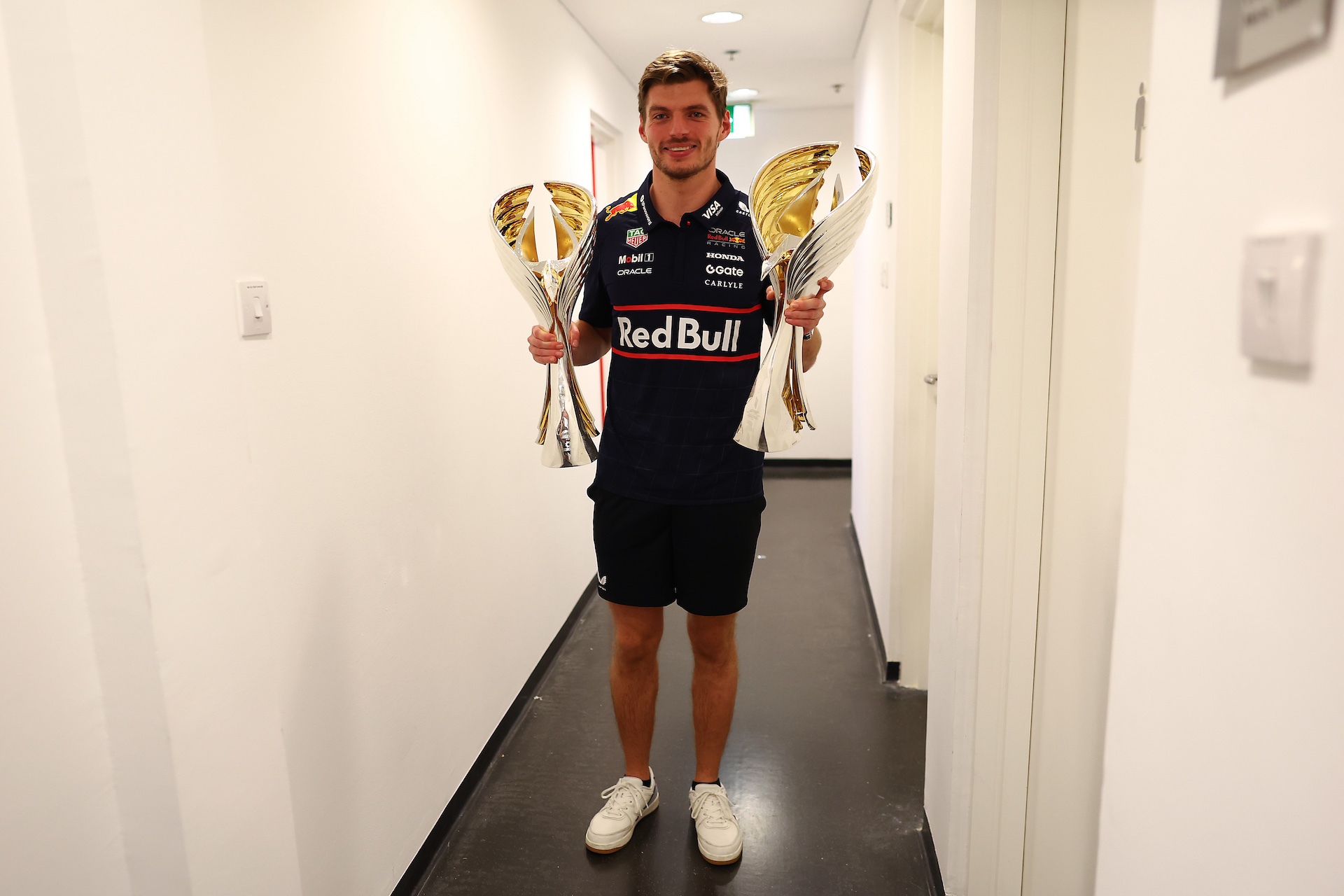 ABU DHABI, UNITED ARAB EMIRATES - DECEMBER 07: Race winner Max Verstappen of the Netherlands and Oracle Red Bull Racing with the winning drivers and constructors trophies during the F1 Grand Prix of Abu Dhabi at Yas Marina Circuit on December 07, 2025 in Abu Dhabi, United Arab Emirates. (Photo by Mark Thompson/Getty Images)