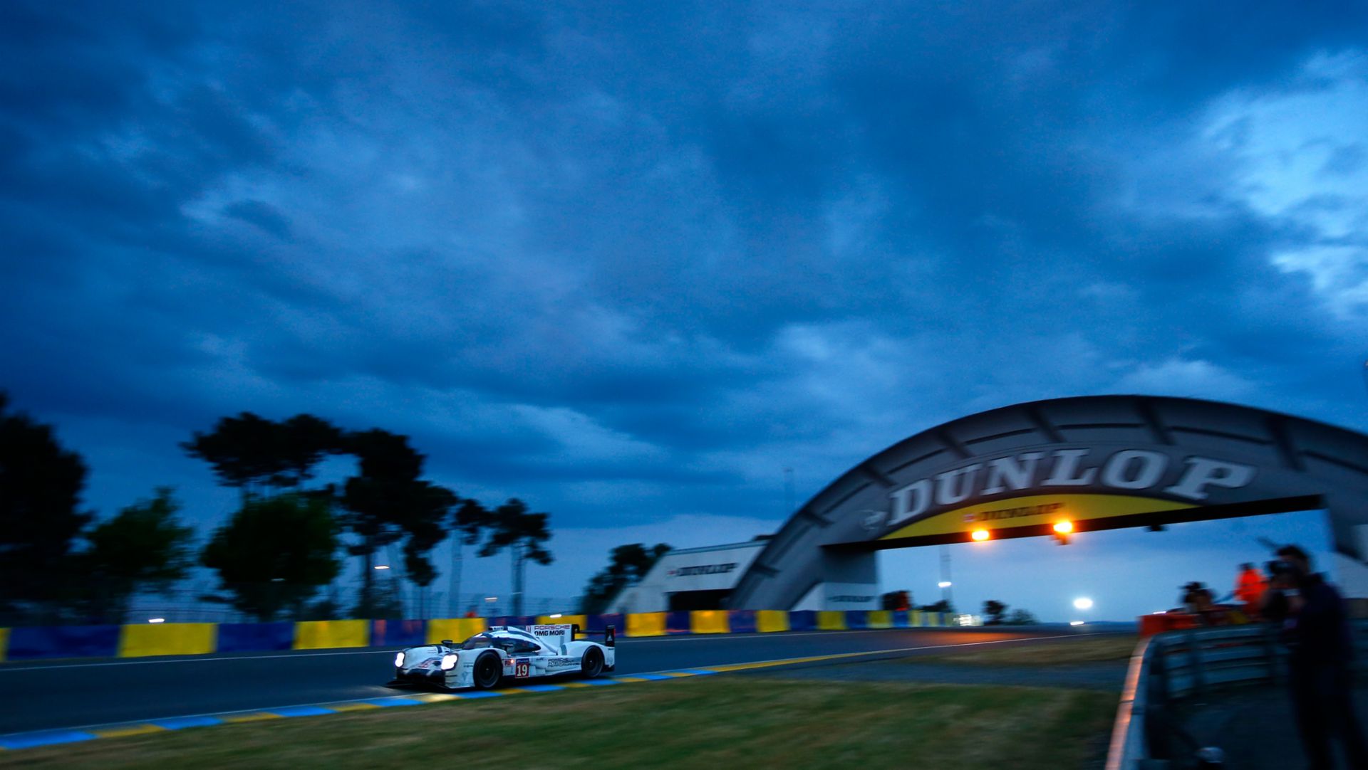A Porsche 919 Hybrid and the Dunlop Bridge with a dramatic sky