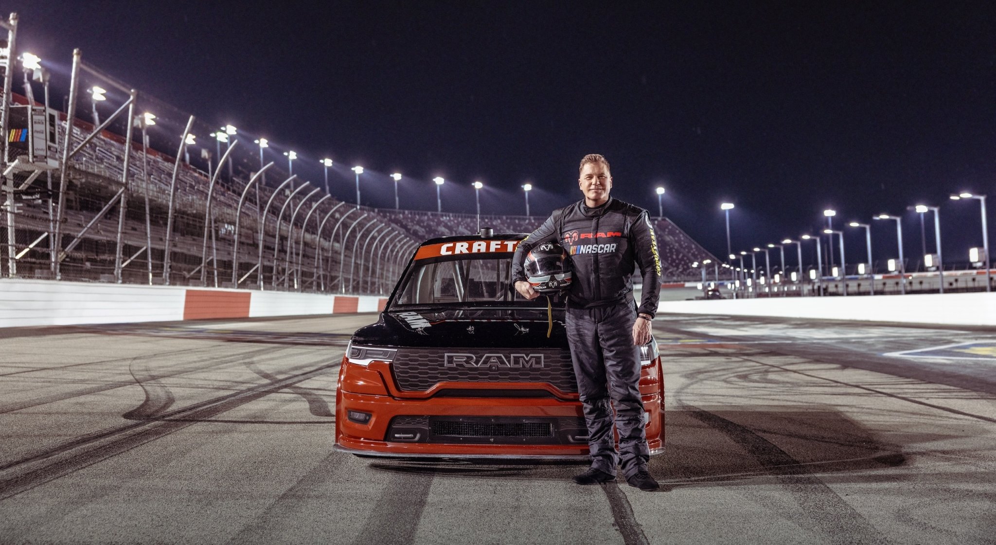 Ram CEO Tim Kuniskis stands in front of the Ram 1500 NASCAR Concept hero
